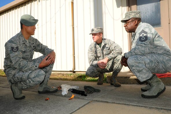 Staff Sgt. Young Lee, 8th Operations Support Squadron Survival, Evasion, Resistance and Escape specialist, gives a survival demonstration to Col. Ken “Wolf” Ekman, 8th Fighter Wing commander, and Chief Master Sgt. Lee “Wolf Chief” Barr, 8th FW command chief, at Kunsan Air Base, Republic of Korea, Nov. 7, 2014. Lee was recognized as the “pride of the pack” outstanding performer and received the chance to show Wolf and Wolf Chief how he contributes to the Wolf Pack mission. (U.S. Air Force photo by Senior Airman Taylor Curry/Released)