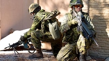 Two Canadian soldiers provide security for coalition forces during an assault on a combat town in Marine Corps Base Camp Lejeune, North Carolina on Nov. 7, 2014. This was one of the many training events of Bold Alligator 2014. A large-scale amphibious exercise on the East Coast designed to improve U.S. and allied forces response to a myriad of different crises. Allies from Canada, the United Kingdom, the Netherlands, Spain and Italy participated in the assault.
