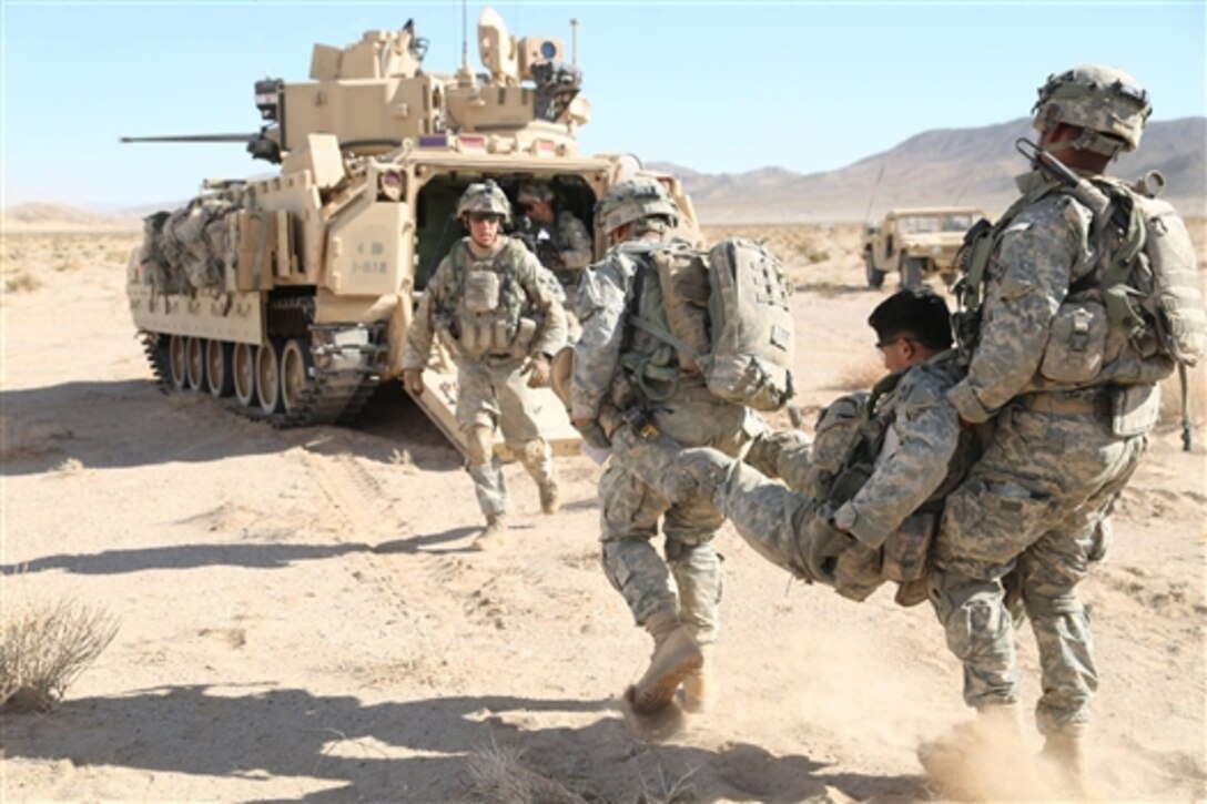 Soldiers from 3rd Brigade Combat Team, 4th Infantry Division, evacuate a simulated casualty during Decisive Action Rotation 15-02 at the National Training Center, Fort Irwin, Calif., Nov. 6, 2014. 
