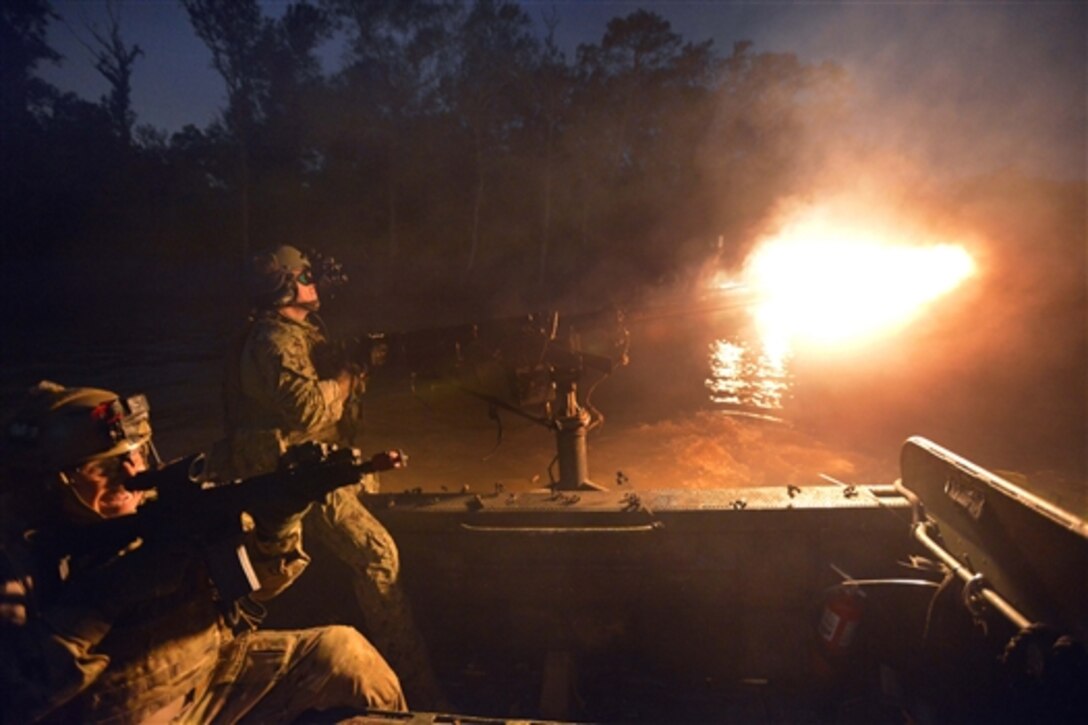 Army Green Berets fire machine guns while participating in a night assault during Southern Strike 15 exercise in Biloxi, Miss., Nov. 6, 2014. 