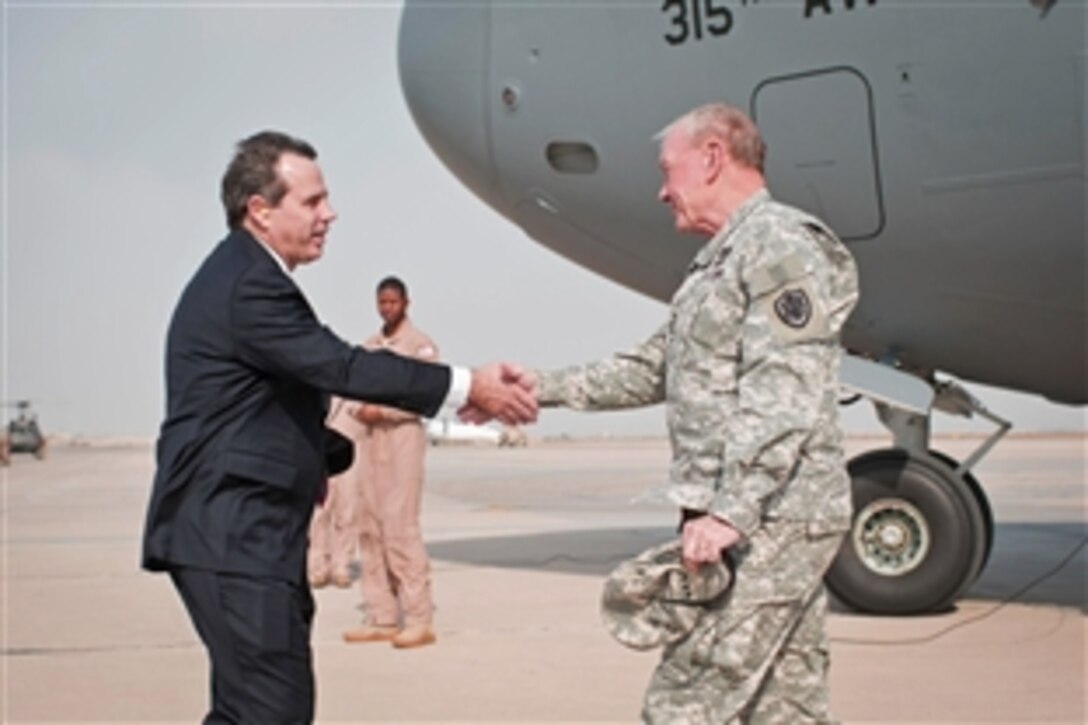 Stuart E. Jones, U.S. ambassador to Iraq, greets U.S. Army Gen. Martin E. Dempsey, chairman of the Joint Chiefs of Staff, as he arrives in Baghdad, Nov. 15, 2014. Dempsey is visiting deployed U.S. service members, civilians and Iraqi leaders.