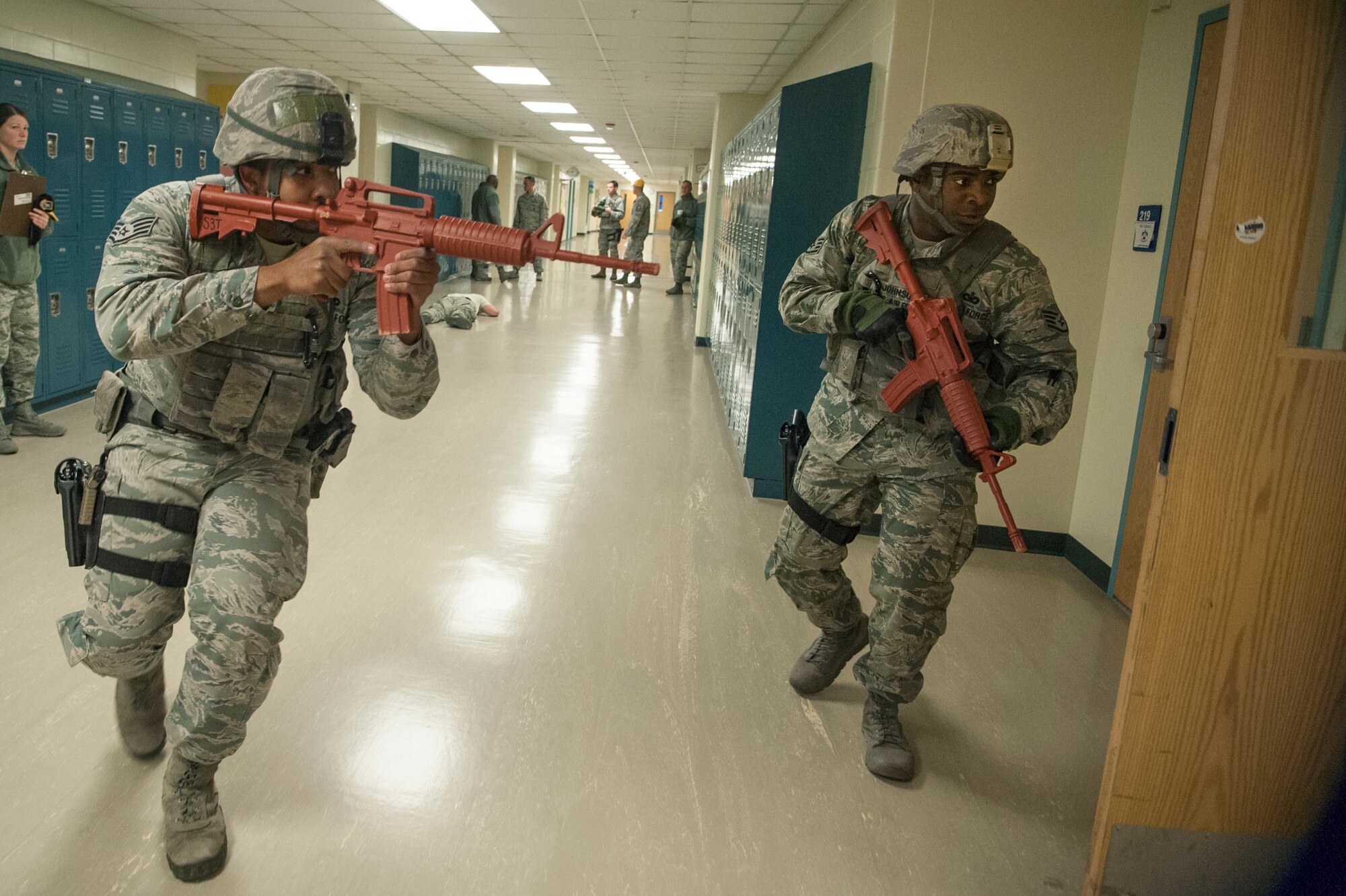 Staff Sgt. Pierre Johnson and Staff Sgt. Carl Higgins, 51st Security Forces Squadron patrolmen, clear the second floor of Osan Middle School during an active shooter exercise at Osan Air Base, Republic of Korea, Nov. 13, 2014. The exercise was to test patrolmen on their response to an active shooter at a school. (U.S. Air Force photo by Senior Airman Matthew Lancaster)