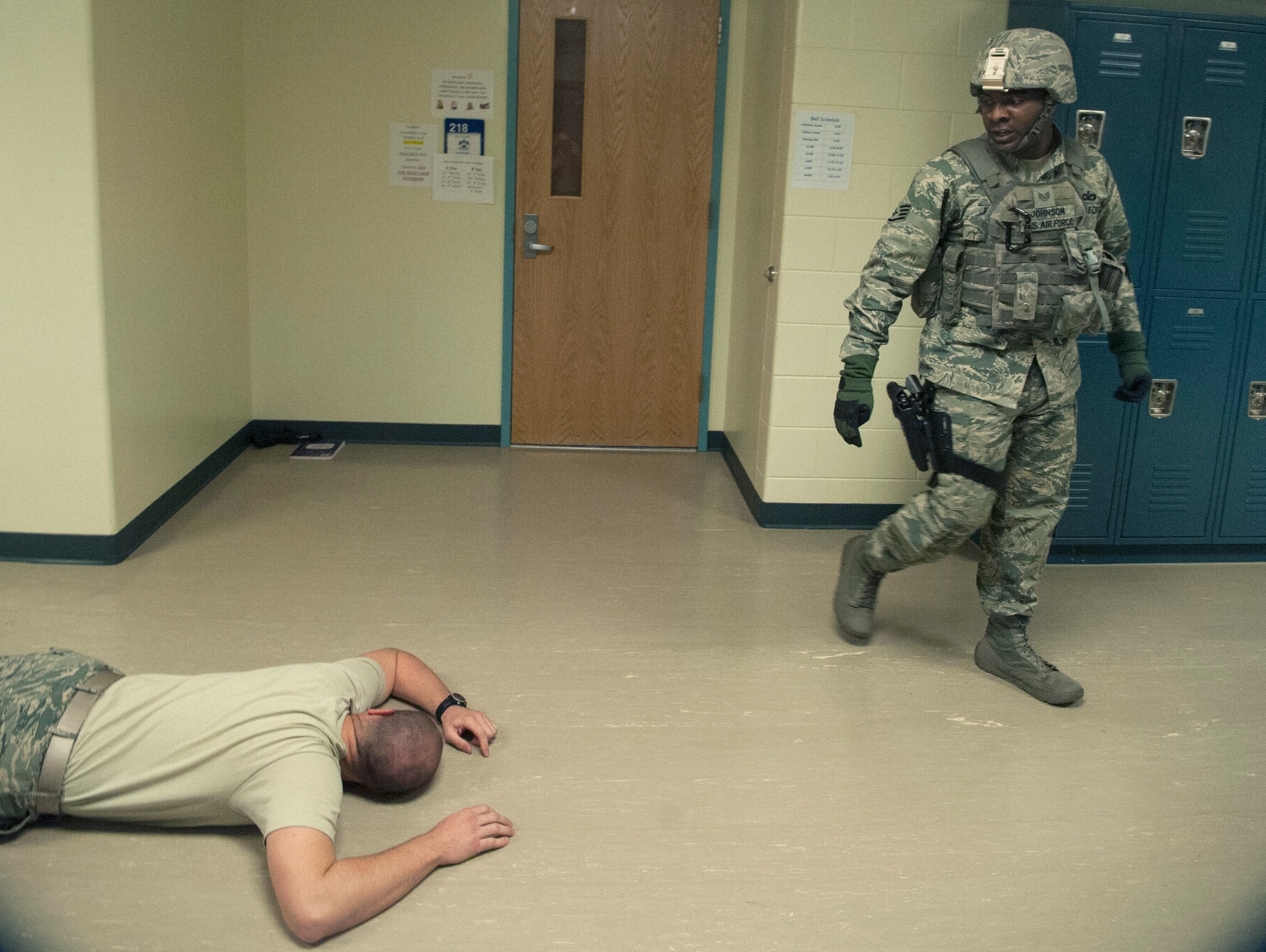 Staff Sgt. Pierre Johnson, 51st Security Forces Squadron patrolman, checks the body of the shooter during an active shooter exercise at Osan Air Base, Republic of Korea, Nov. 13, 2014. Active shooter exercises are done to prepare responders for real-world scenario. (U.S. Air Force photo by Senior Airman Matthew Lancaster)
