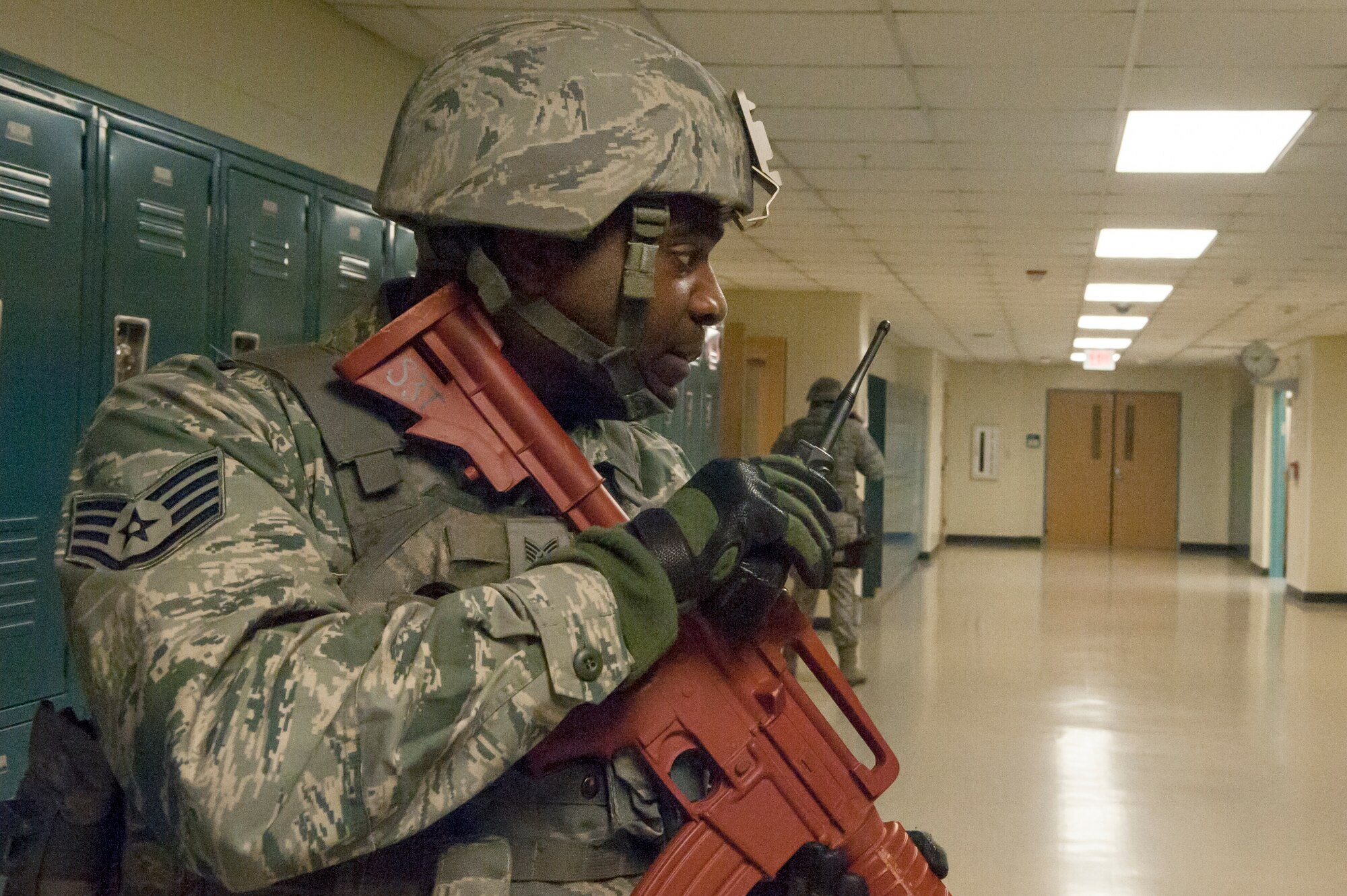 Staff Sgt. Pierre Johnson, 51st Security Forces Squadron patrolman, radios for addition information on the situation during an active shooter exercise at Osan Air Base, Republic of Korea, Nov. 13, 2014. Any information provided will help responders with handling the situation better. (U.S. Air Force photo by Senior Airman Matthew Lancaster)