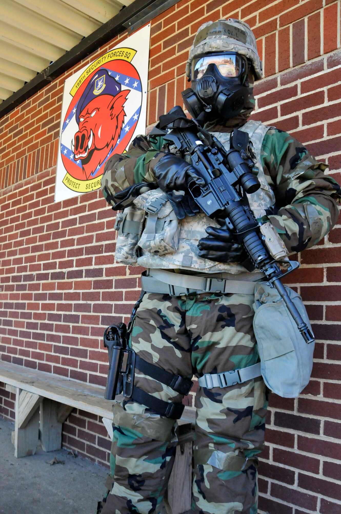 Senior Airman Adam Carroll, 188th Security Forces Squadron, stands ready in full mission oriented protective posture gear during an ability to survive and operate exercise at Ebbing Air National Guard Base, Fort Smith, Ark., Nov. 2, 2014. The objective of the exercise was to test the wing’s ability to react to various attacks. (U.S. Air National Guard photo by Staff Sgt. John Suleski/released)