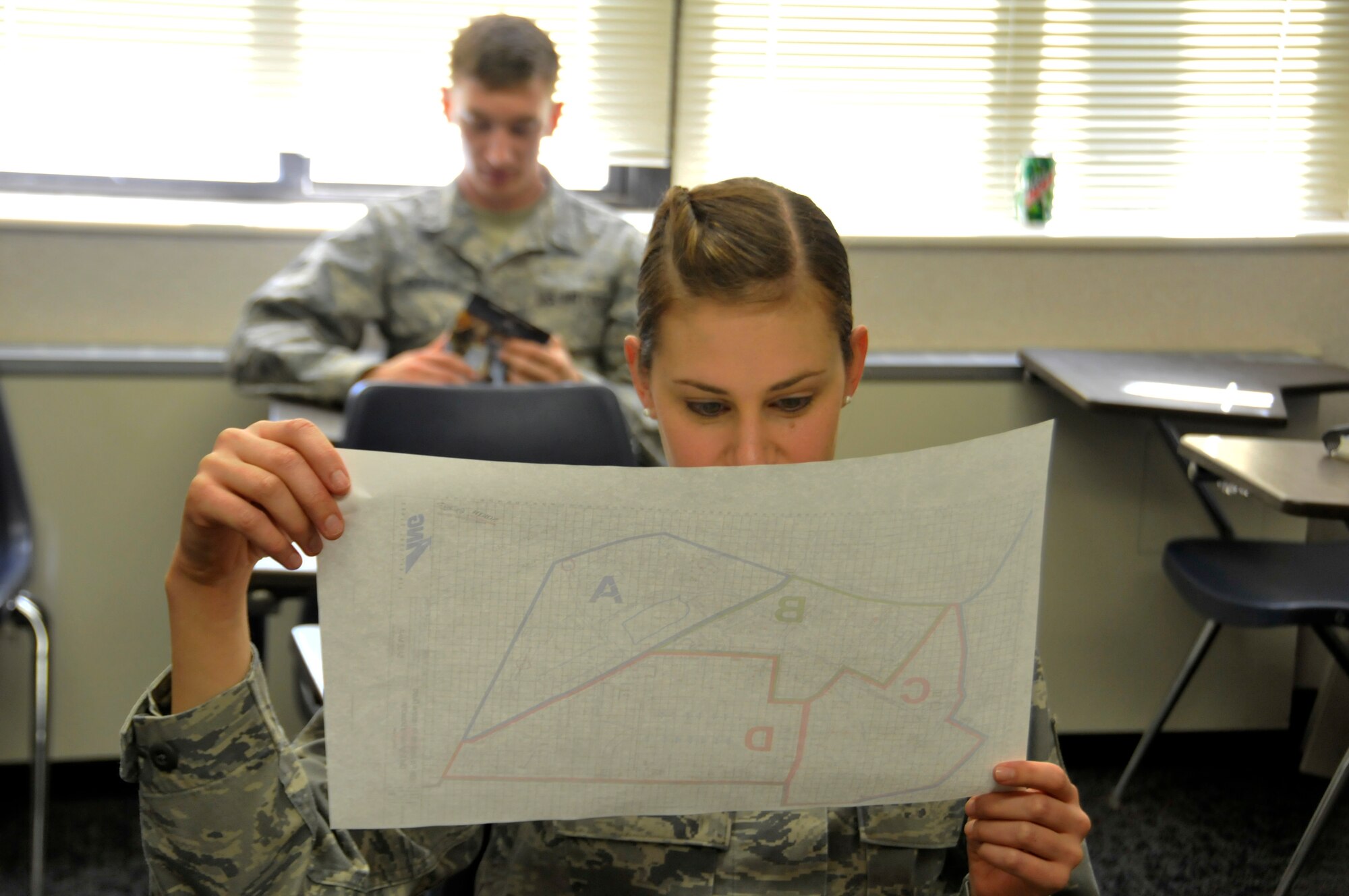 Tech. Sgt. Corinna Rankin, 188th Medical Group Airman, studies a map of a training scenario during an ability to survive and operate exercise at Ebbing Air National Guard Base, Fort Smith, Ark., Nov. 2, 2014. The objective of the exercise was to test the wing’s ability to react to various attacks. (U.S. Air National Guard photo by Staff Sgt. John Suleski/released) 