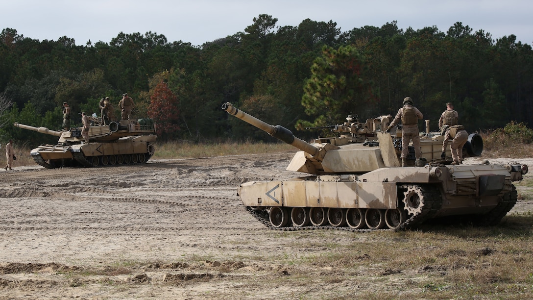 Marines with Tank Platoon, Company B, Ground Combat Element Integrated Task Force, stage M1A1 Abrams tanks at Landing Zone Hawk at Marine Corps Base Camp Lejeune, North Carolina, Nov. 13, 2014. From October 2014 to July 2015, the GCEITF will conduct individual and collective level skills training in designated ground combat arms occupational specialties in order to facilitate the standards based assessment of the physical performance of Marines in a simulated operating environment performing specific ground combat arms tasks. 