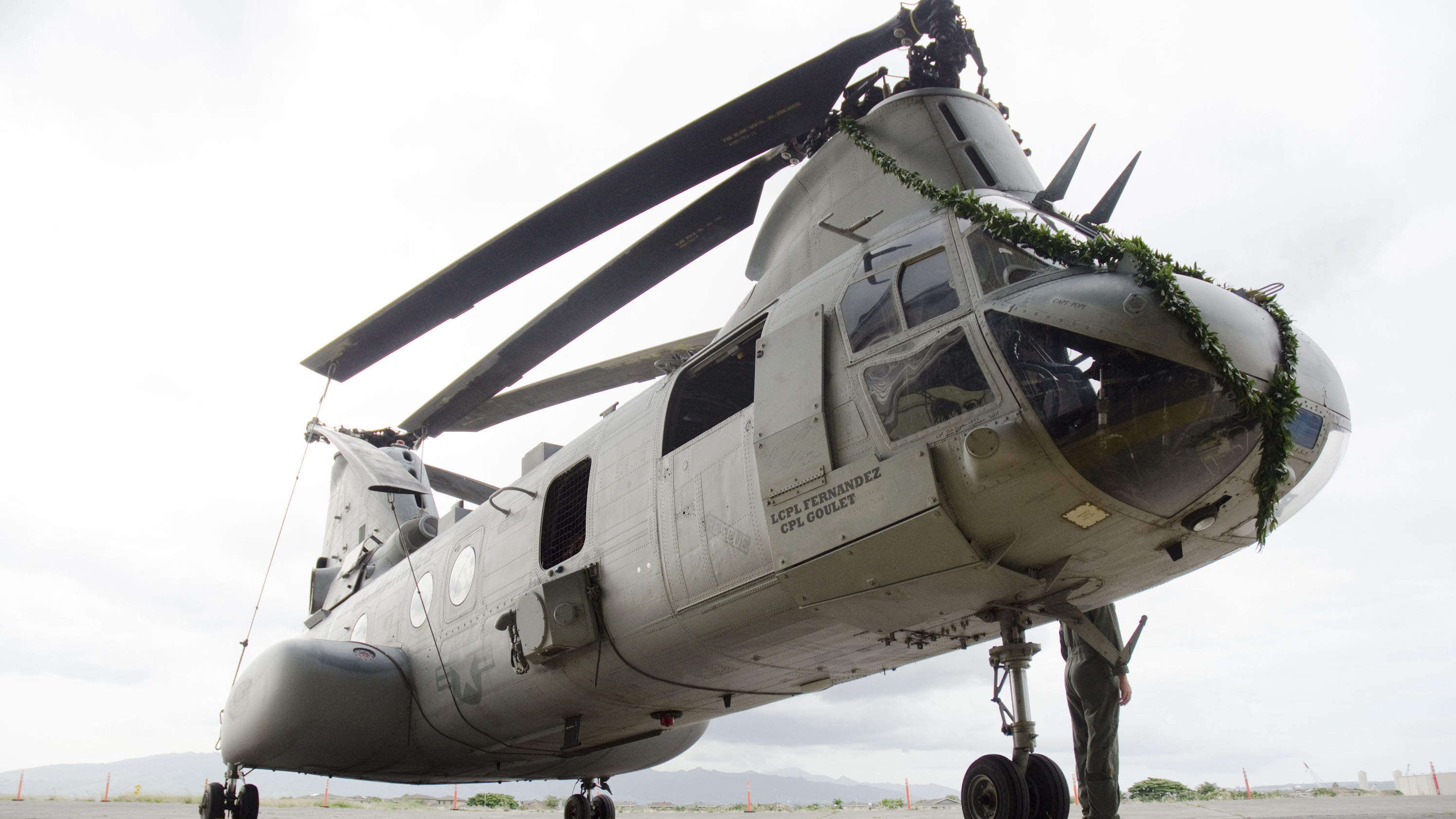 A CH-46E Sea Knight helicopter approaches amphibious dock landing