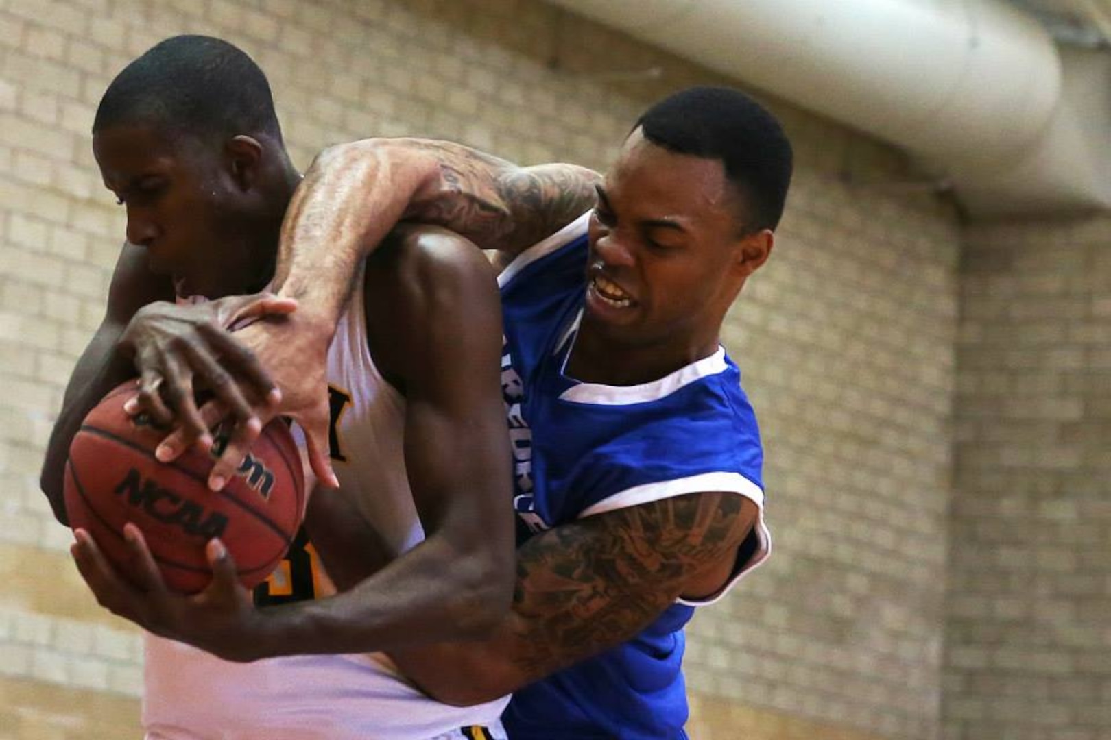 Jahmal Lawson attempts to steal the ball from Ella Ellis during the Armed Forces Basketball Championship at the Paige Fieldhouse, Nov. 8. The Air Force Men's team beat the Army 80-69 during the second day of the playoffs, moving to 2-0 while the Army is at 1-1. The Basketball Championship finals will be held on Nov. 13.