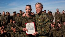 Corporal Joshua R. Gregory (left), a ground support equipment mechanic with Marine Aviation Logistics Squadron 13, based out of Marine Corps Air Station Yuma, Ariz., was meritoriously promoted by the 35th Commandant of the Marine Corps, Gen. James F. Amos, at the station’s flight line on Thursday. Amos’ presence at the ceremony surprised Gregory, as did the additional award of the 3rd Marine Aircraft Wing Marine of the Year.