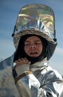 A firefighter Marine from Marine Corps Air Station Miramar, Calif., quickly dons his “bunker” gear during the 3rd Annual Aircraft Rescue and Fire Fighting Rodeo Competition at MCAS Yuma, Ariz., Saturday. Each event was timed and each team received points depending on which team had the overall fastest time.