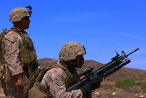 Lance Cpl. Keith Whitaker, a combat engineer with Marine Wing Support Squadron 371, based out of Marine Corps Air Station Yuma, Ariz., verifies his target after firing an M-203 grenade launcher, as Sgt. John Reyes, also a combat engineer with MWSS-371, oversees his progress at Yuma Proving Grounds in Yuma, Ariz., Tuesday. Combat engineers from MWSS-371 practiced automatic weapons training by firing the M-203 grenade launcher, the M-32 multiple grenade launcher, and the MK 19 automatic grenade launcher in order to be better prepared for future missions.


