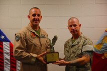Lt. Col. Toby Moore (left), the Commanding Officer of Marine Attack Squadron 311, hold the Lawson H.M. Sanderson Award, which is awarded to the Marine Attack Squadron of the Year. VMA-311 deployed to Camp Bastion, Afghanistan and provided uninterrupted aviation support during 2013. The squadron also deployed a detachment of Marines to the 15th Marine Expeditionary Unit.


