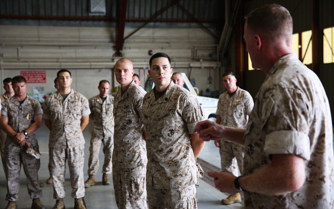 Cpl. Ryan Remington, center-left, an air traffic controller at Marine Corps Air Station Yuma, Ariz., and a native of Kalispell, Mo., and Staff Sgt. John Dellacamera, center, also an air traffic controller at MCAS Yuma and a native of North Haven, Conn., are recognized for their exemplary service in the line of duty by Brig. Gen. Edward D. Banta, right, the commanding general of Marine Corps Installations West and Marine Corps Base Camp Pendleton, Calif., Aug. 25, 2014.