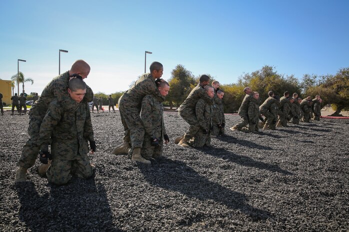 Recruits of Mike Company, 3rd Recruit Training Battalion, execute a figure-four rear choke during the Marine Corps Martial Arts Program test aboard Marine Corps Recruit Depot San Diego, Nov. 12.  Recruits were tested on how to perform the choke holds as well as how to counter them.