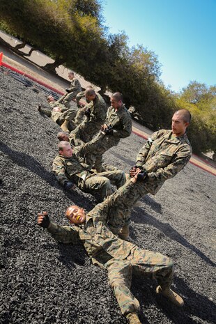 Recruits of Mike Company, 3rd Recruit Training Battalion, perform a basic wrist-lock takedown during the Marine Corps Martial Arts Program test aboard Marine Corps Recruit Depot San Diego, Nov. 12.  The MCMAP test is a graduation requirement, therefore, it is critical for recruits to be successful on test day.