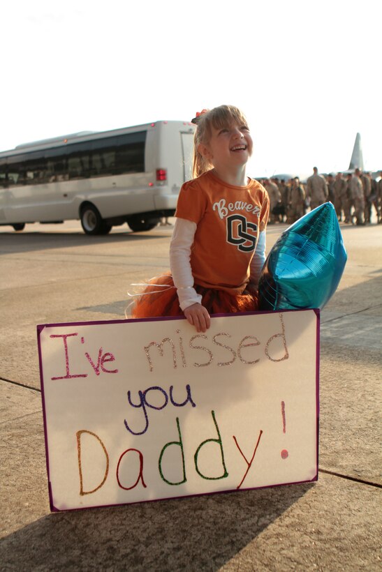 Hannah W. holds a balloon and sign while awaiting the return of her father during a return party for Marine Heavy Helicopter Squadron 366 at Marine Corps Air Station Cherry Point, N.C., Nov. 17, 2014. 
HMH-366 departed Camp Bastion at the end of October, marking the sunset of Regional Command Southwest and the end of the International Security Assistance Force’s operational control of Helmand Province, Afghanistan. With the departure of HMH-366, both Camp Leatherneck and Camp Bastion, a once sprawling hub of combat power in Southwestern Afghanistan, are under the tactical and operational control of Afghan security forces. 