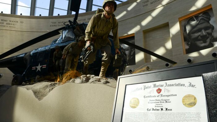 Almost 70 years later families, friends, service members and the Honorable Senator Mark R. Warner gathered at the National Museum of the Marine Corps to remember fallen Montford Marine, Cpl. Julius B. Foxx, by awarding his family with the Congressional Gold Medal, Nov. 14.  Nearly seven decades ago, as our Nation was at war, more than 2,000 African-American men enlisted in the United States Marine Corps with Foxx being one of many Marines who served with distinction during some of World War II’s bloodiest struggles after completing arduous and segregated basic training at Montford Point Camp. (U.S. Marine Corps Photo By Sgt. Jose D. Lujano/Released)