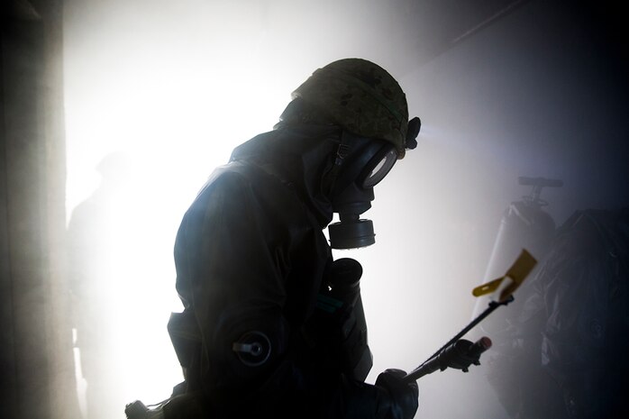 2nd Central Nuclear Biological Chemical Weapon Defense Unit makes his way through a smoke filled room inside the fire training tower aboard Marine Corps Air Station Iwakuni, Japan, Nov. 7, 2014. The 102nd Central NBC Weapon Defense Unit, Marine Aircraft Group 12, and the MCAS Iwakuni Fire Station collaborated to conduct interoperability training while executing Chemical Biological Radiological Nuclear and Hazardous Material Emergency Response Operations.
