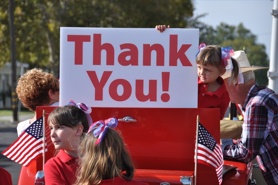 A little girl holds a thank you sign while watching the Yuba/Sutter Veterans Day Parade in downtown Marysville, Calif., Nov. 11, 2014. Veterans Day is celebrated throughout the U.S. to honor those who have served and are serving in the military. (U.S. Air Force photo by Tech. Sgt. Heather Skinkle/Released) 
