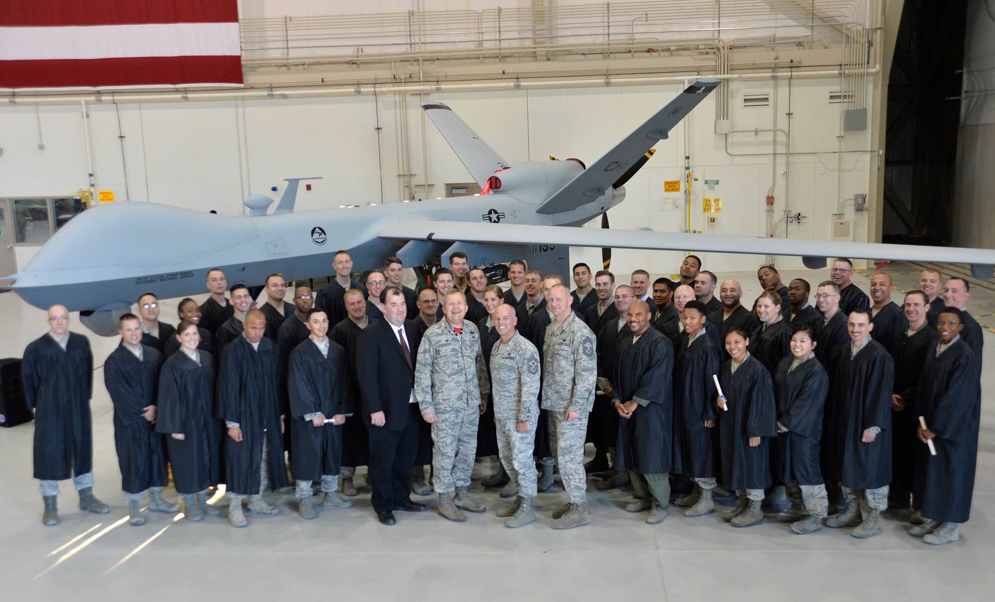 Creech leadership and Community College of the Air Force graduates pose for a group photo following Creech Air Force Base’s first-ever Community College of the Air Force graduation, which took place on base Nov. 14, 2014. Some of the Creech private organizations to include the Top III, Chiefs Group, First Sergeants Group, Air Force Sergeants Association-Chapter 1253, the NCO Council, and Operation Warm Heart collectively donated $1,900 in scholarship money during the ceremony. (U.S. Air Force photo by Staff Sgt. Adawn Kelsey)
