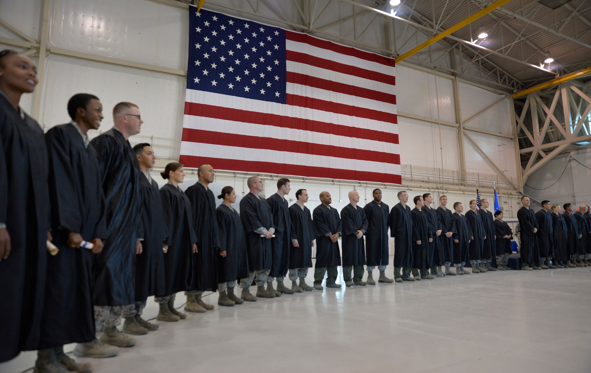 Students line up in preparation to sing the Air Force song during Creech Air Force Base’s first-ever Community College of the Air Force graduation, which took place on base Nov. 14, 2014. More than 100 Creech Airmen received their associate of applied science degree. (U.S. Air Force photo by Staff Sgt. Adawn Kelsey)