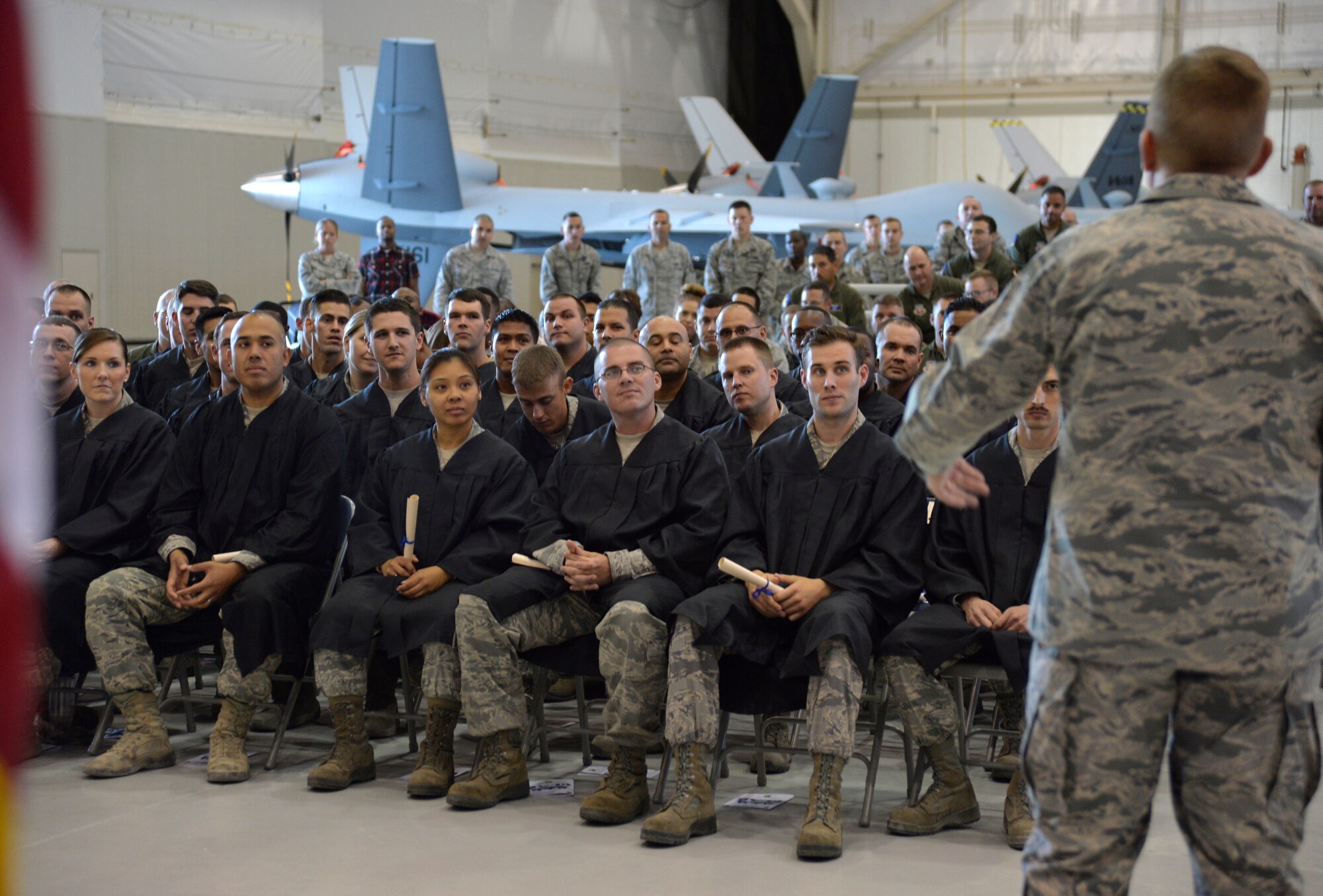 Col. James Cluff, 432nd Wing/432nd Air Expeditionary Wing commander, gives a speech during Creech Air Force Base’s first-ever Community College of the Air Force graduation, which took place on base Nov. 14, 2014. Combined, Nellis and Creech Air Force base have more than 400 Airmen who received diplomas during the fall CCAF graduating class. (U.S. Air Force photo by Staff Sgt. Adawn Kelsey)
