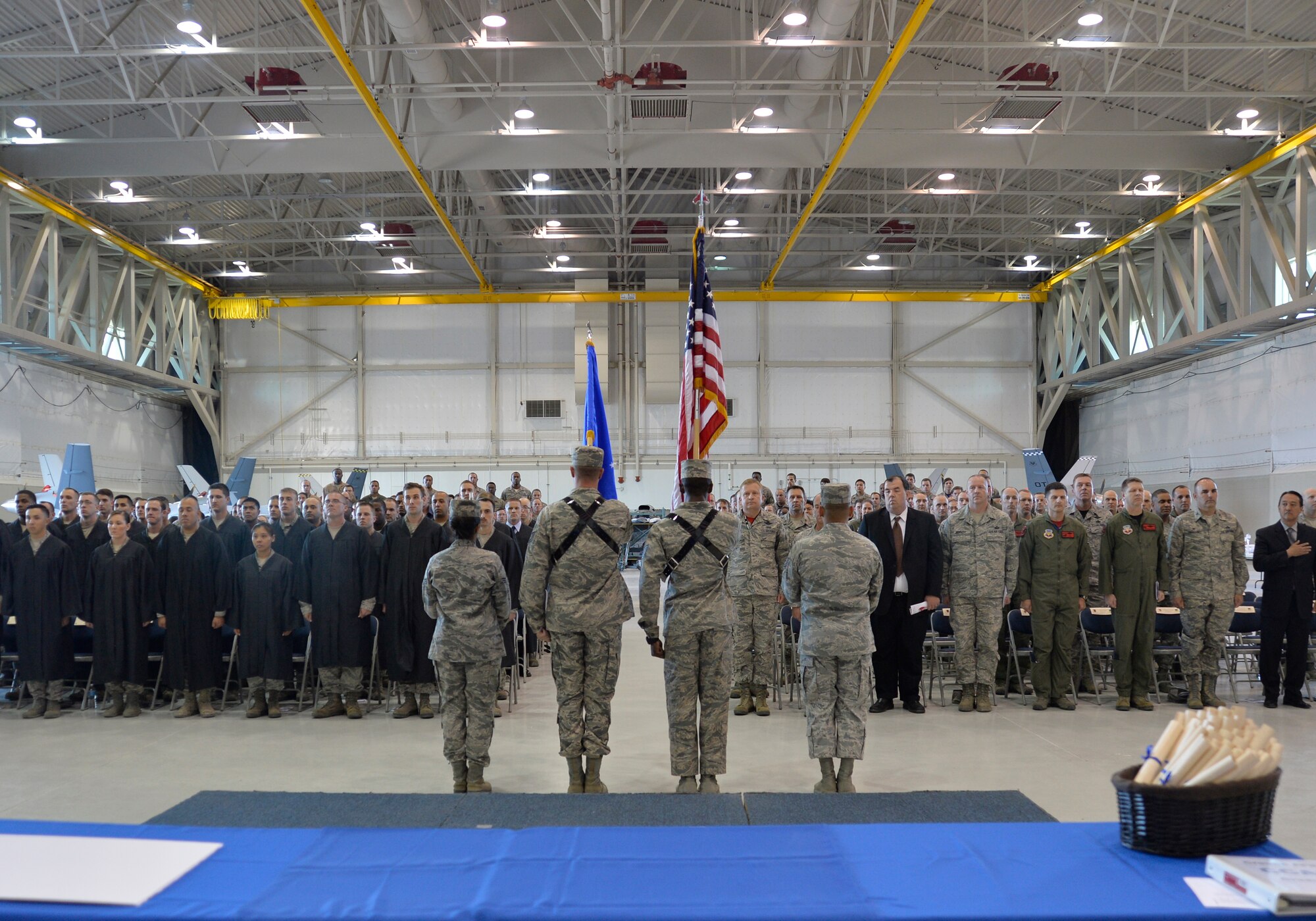 The Creech Ceremonial Team presents the colors during the singing of the national anthem at Creech Air Force Base’s first-ever Community College of the Air Force graduation, which took place on base Nov. 14, 2014. More than 100 Creech Airmen received their associate of applied science degree. (U.S. Air Force photo by Staff Sgt. Adawn Kelsey)