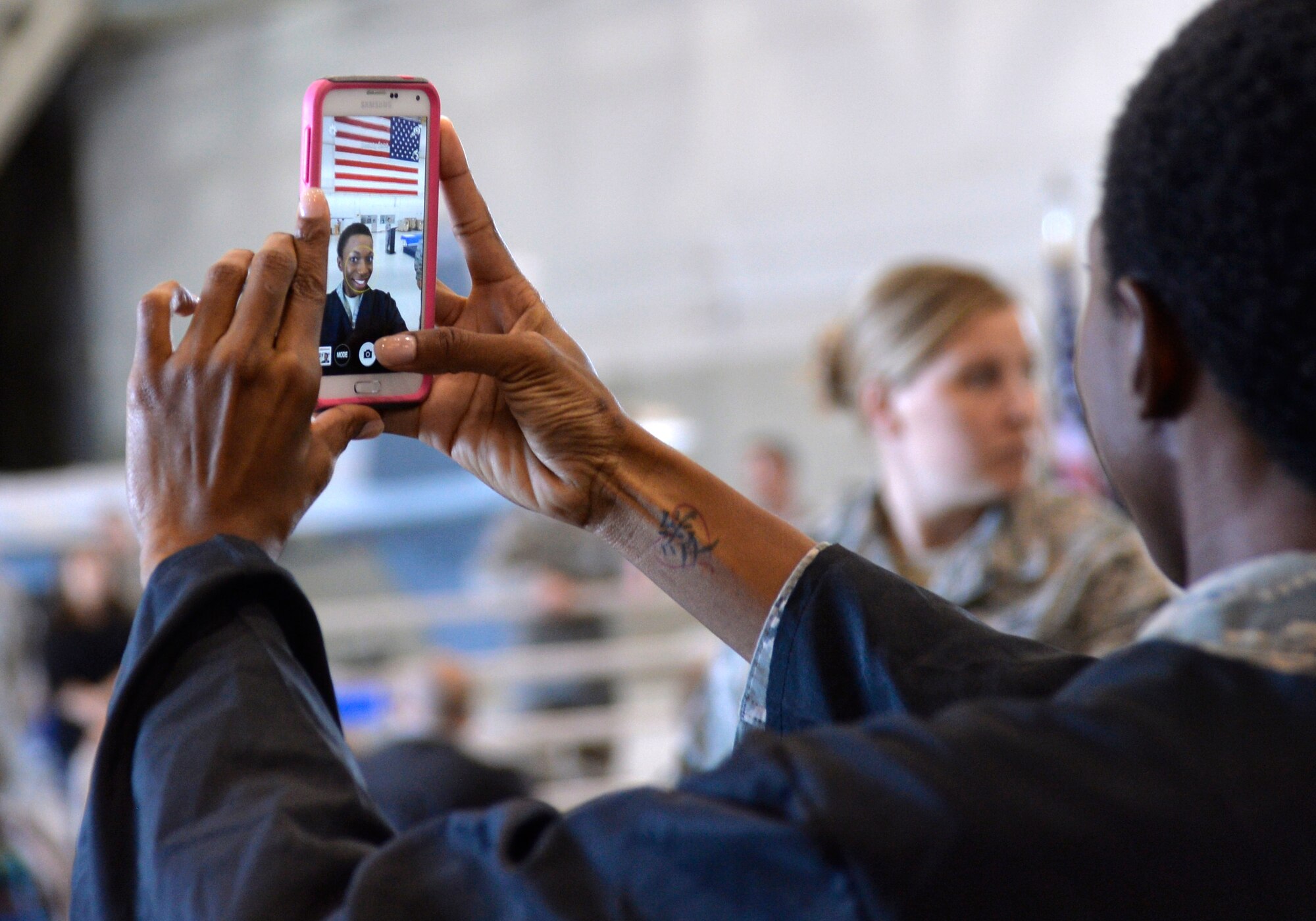 Staff Sgt. Alexisa Humphrey, 99th Ground Combat Training Squadron independent duty medical technician, takes a selfie before Creech Air Force Base’s first-ever Community College of the Air Force graduation, which took place on base Nov. 14, 2014. Some of the Creech private organizations to include the Top III, Chiefs Group, First Sergeants Group, Air Force Sergeants Association-Chapter 1253, NCO Council, and Operation Warm Heart collectively donated $1,900 in scholarship money during the ceremony. (U.S. Air Force photo by Staff Sgt. Adawn Kelsey)