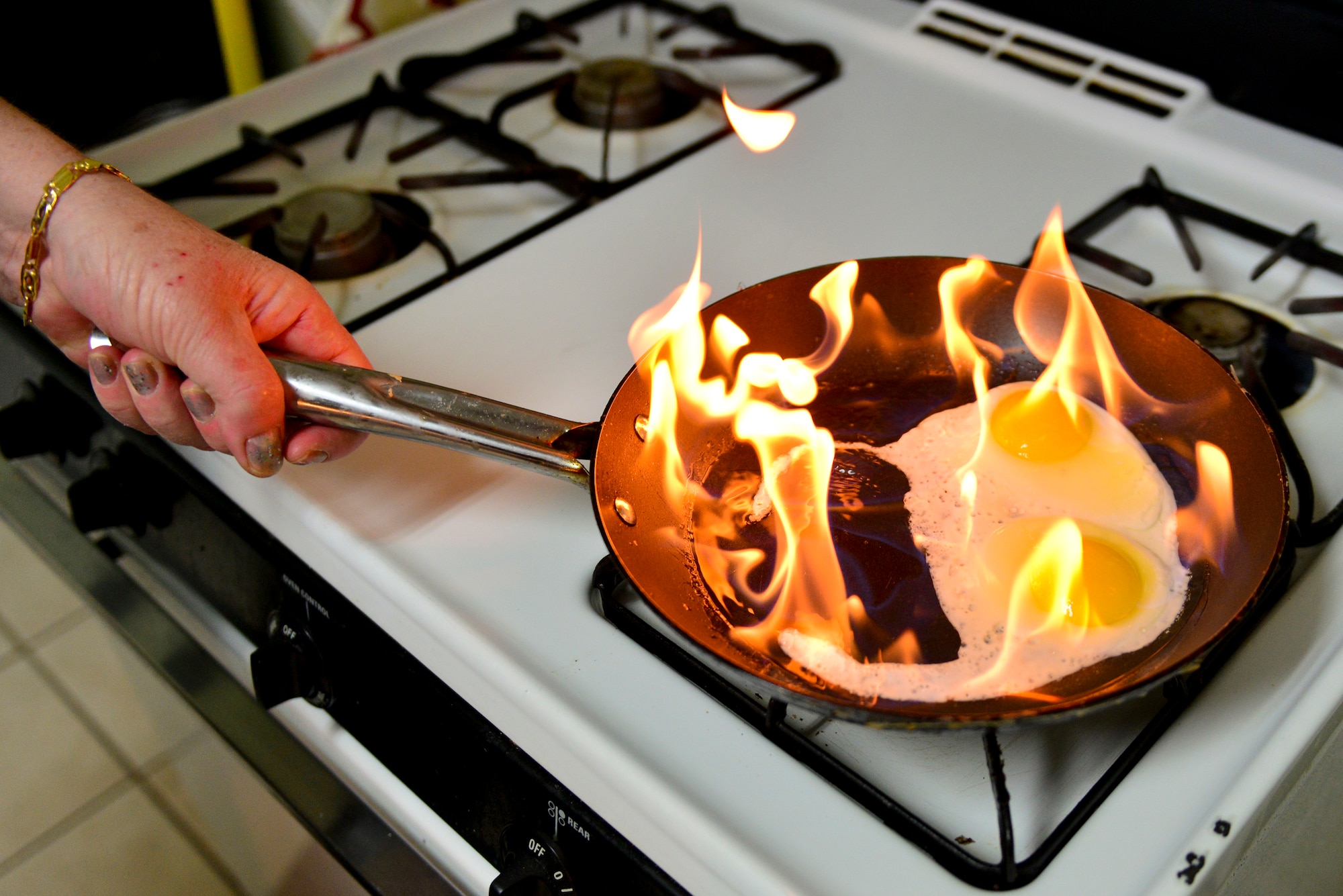 Thanksgiving brings families and friends together to share a meal, conversation and laughter, but it also comes with an increased risk of fires. One tip to eliminate a flame is to cover the pan, putting out the fire. (U.S. Air Force Photo illustration/Airman 1st Class Mozer Da Cunha)
