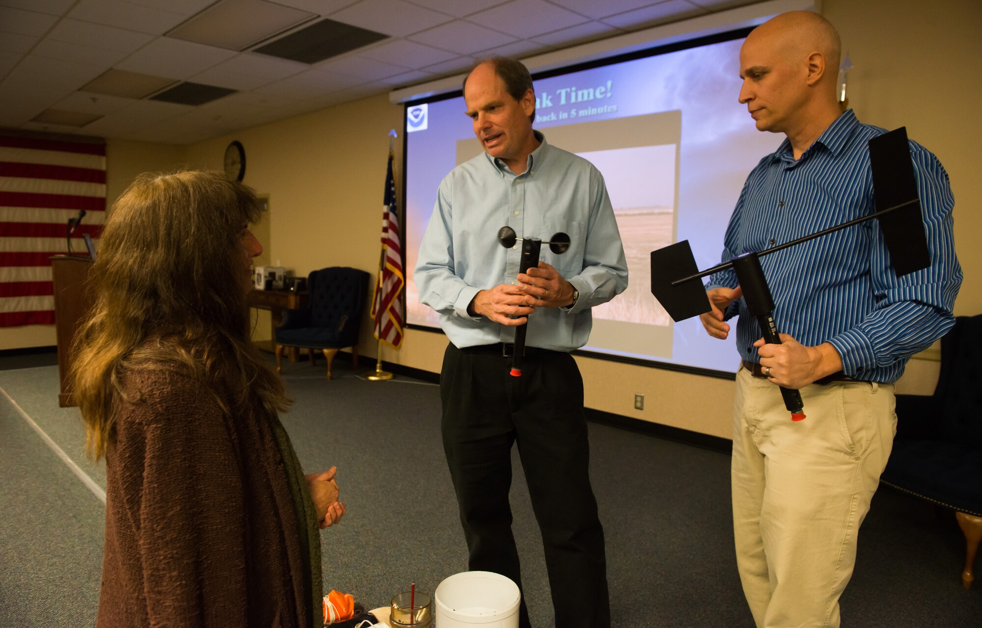 National Weather Service meteorologists explain the importance of being able to identify weather formations Nov. 11, 2014, at Mountain Home Air Force Base, Idaho. The NWS gave a severe weather spotter presentation to help educate the public. (U.S. Air Force photo by Airman Connor J. Marth/RELEASED)