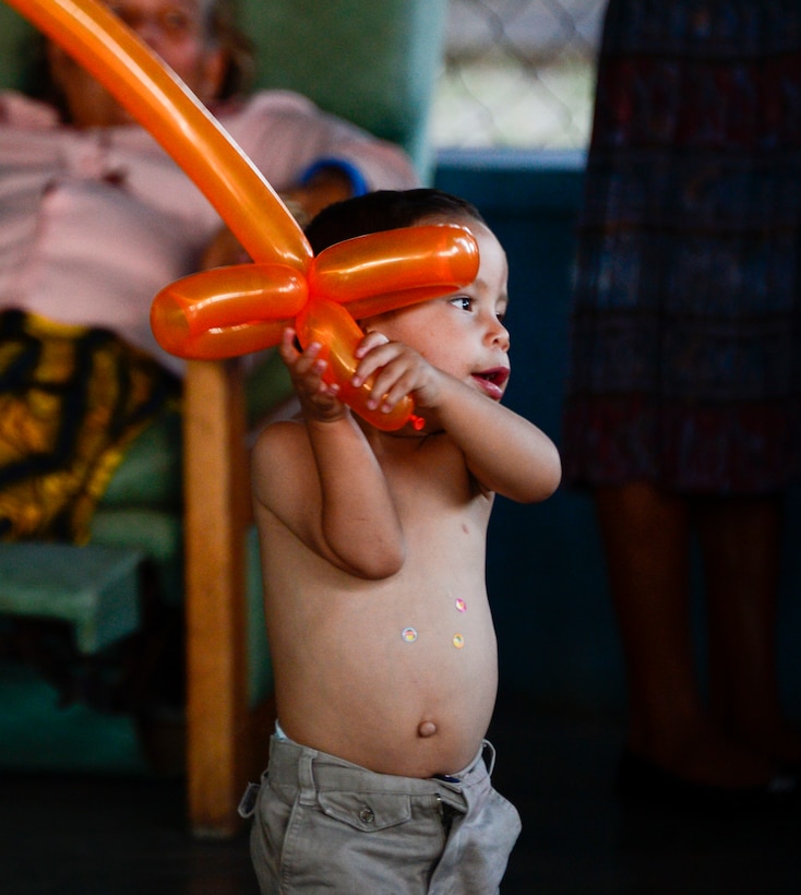 A young boy plays with a balloon sword during Joint Task Force-Bravo’s visit to the Sisters of Charity Orphanage in Comayagua, Honduras, Nov. 16, 2014.  The Sisters of Charity Orphanage is one of seven different orphanages from around the Comayagua Valley that the U.S. military personnel assigned to JTF-Bravo have supported over the past 17 years. In addition to spending time with interacting with children, members have also collected and donated much-needed supplies and food, as well as helped in minor construction work on the buildings in which the children live. (U.S. Air Force photo/Tech. Sgt. Heather Redman)