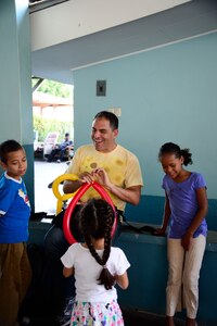 U.S. Air Force Master Sgt. Carlos Hampton, non-commissioned officer in charge of Air Traffic Control Training and Standardization for the 612th Air Base Squadron, makes balloon hats for children from the Sisters of Charity Orphanage in Comayagua, Honduras, Nov. 16, 2014.  The Sisters of Charity Orphanage is one of seven different orphanages from around the Comayagua Valley that the U.S. military personnel assigned to JTF-Bravo have supported over the past 17 years. In addition to spending time with interacting with children, members have also collected and donated much-needed supplies and food, as well as helped in minor construction work on the buildings in which the children live. (U.S. Air Force photo/Tech. Sgt. Heather Redman)