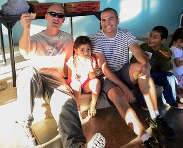 U.S. Air Force Capt. Samuel McClellan, Joint Task Force-Bravo command chaplain, and U.S. Army Sgt. Joshua Smith, Joint Task Force-Bravo chaplain assistant, share a pizza dinner with children from the Sisters of Charity Orphanage in Comayagua, Honduras, Nov. 16, 2014.  The Sisters of Charity Orphanage is one of seven different orphanages from around the Comayagua Valley that the U.S. military personnel assigned to JTF-Bravo have supported over the past 17 years. In addition to spending time with interacting with children, members have also collected and donated much-needed supplies and food, as well as helped in minor construction work on the buildings in which the children live. (U.S. Air Force photo/Tech. Sgt. Heather Redman)