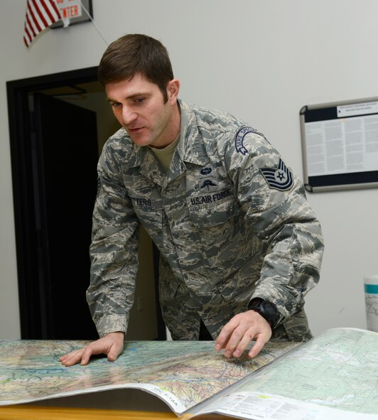 Tech. Sgt. Justin Watters, 22nd Operations Support Squadron Survival Escape Resistance and Evade specialist, explains features of a map during a land navigation class, Nov. 17, at McConnell Air Force Base, Kan. SERE specialists teach land navigation and other survival classes to ensure aircrew and other members of Team McConnell are prepared for less than ideal situations. (U.S. Air Force photo/Senior Airman Trevor Rhynes)