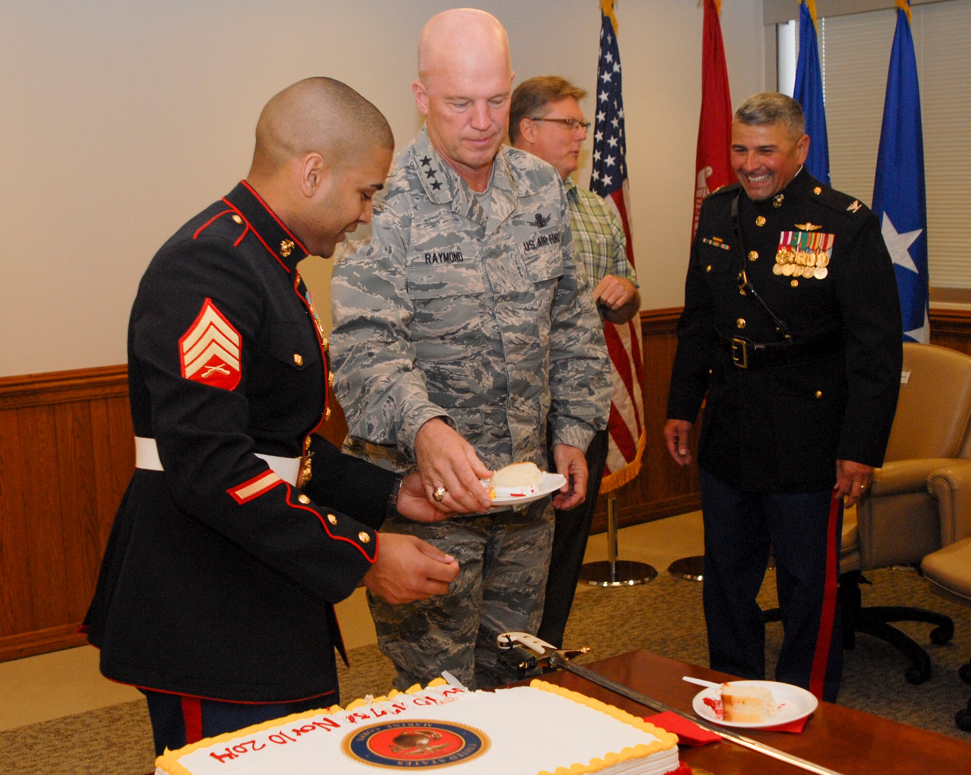 U.S. Marine Corps Sgt. Moses Figueroa, office administrator, Joint Functional Component Command for Space, hands a piece of cake to U.S. Air Force Lt. Gen. John W. “Jay” Raymond, commander, 14th Air Force (Air Forces Strategic) and JFCC Space during a Marine Corps Birthday celebration here, Nov. 12, 2014. On Nov. 10, 2014 the Marine Corps celebrated its 239th birthday. (U.S. Air Force photo by Capt. Nicholas Mercurio/Released)