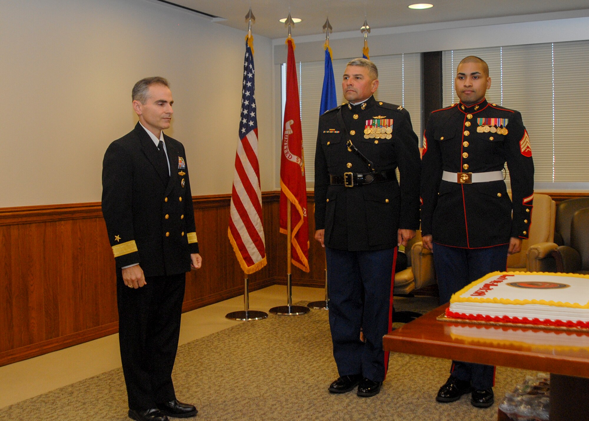U.S. Navy Rear Adm. Brian Brown, deputy commander, Joint Functional Component Command for Space, prepares to participate in a cake-cutting ceremony with U.S. Marine Corps Col. Edward Quinonez, a reservist assigned to the Operations, Fires and Effects Coordination cell, 1st Marine Expeditionary Force, Camp Pendleton, Calif., and Marine Corps Sgt. Moses Figueroa, office administrator, JFCC Space, during a Marine Corps Birthday celebration here, Nov. 12, 2014. On Nov. 10, 2014 the Marine Corps celebrated its 239th birthday.  (U.S. Air Force photo by Capt. Nicholas Mercurio/Released)