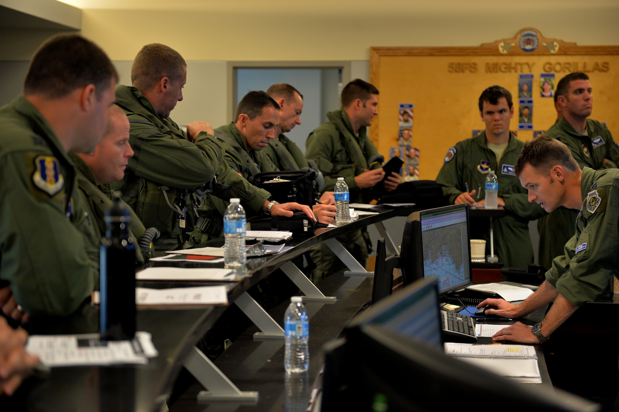 F-35 Lightning II and F-22 Raptor pilots attend a preflight briefing before an integrated training mission on Eglin Air Force Base, Florida, Nov. 6, 2014. The U.S. Air Force deployed four F-22 Raptors from Joint Base Langley-Eustis, Virginia, to Eglin Air Force Base, Florida, for the first operational integration training mission with the F-35A Lightning II assigned to the 33rd Fighter Wing. The purpose of the training was to improve integrated employment of fifth-generation assets and tactics. (U.S. Air Force photo/Master Sgt. Shane A. Cuomo)