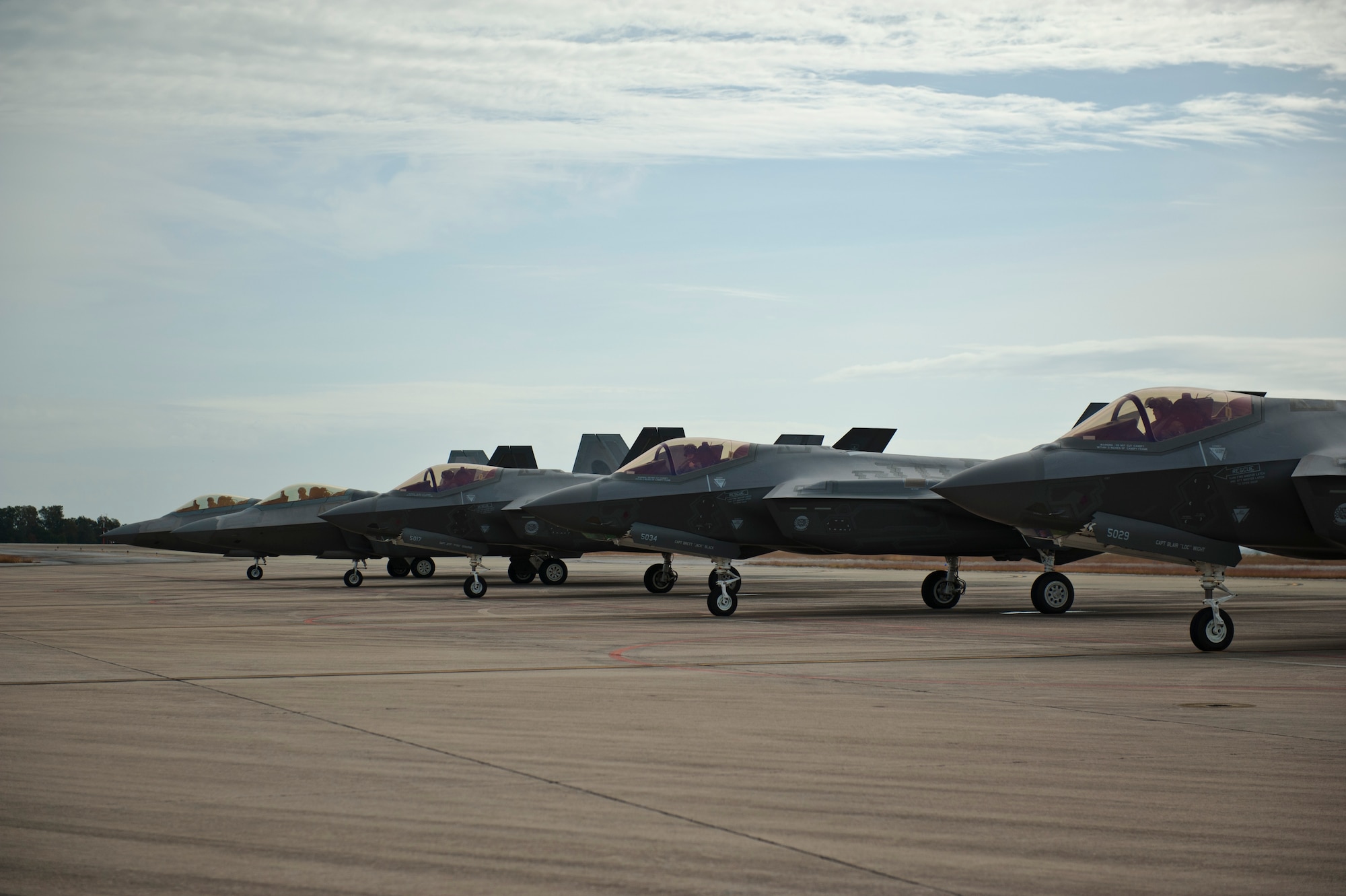 F-22 Raptors from the 94th Fighter Squadron, Joint Base Langley-Eustis, Virginia, and F-35A Lightning IIs from the 58th Fighter Squadron, Eglin Air Force Base, Florida, perform final preflight checks before taking off for an integration training mission on Eglin Training Range, Florida, Nov. 6, 2014. The U.S. Air Force deployed four F-22 Raptors from Joint Base Langley-Eustis, Virginia, to Eglin Air Force Base, Florida, for the first operational integration training mission with the F-35A Lightning II assigned to the 33rd Fighter Wing. The purpose of the training was to improve integrated employment of fifth-generation assets and tactics. (U.S. Air Force photo/Staff Sgt. Marleah Robertson)