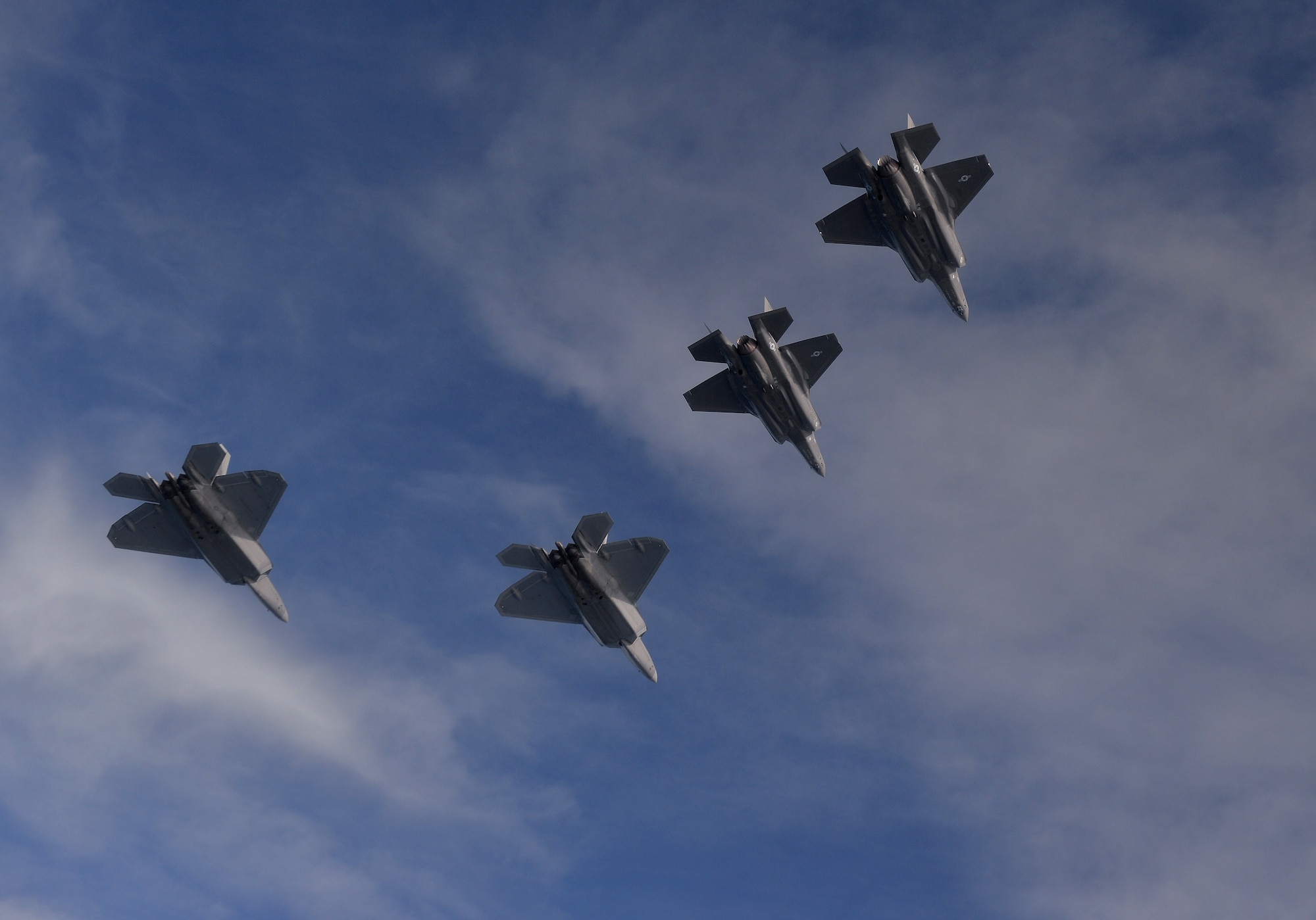 F-22 Raptors from the 94th Fighter Squadron, Joint Base Langley-Eustis, Virginia, and F-35A Lightning IIs from the 58th Fighter Squadron, Eglin Air Force Base, Florida, fly in formation after completing an integration training mission over the Eglin Training Range, Florida, Nov. 5, 2014.  The F-35s and F-22s flew offensive counter air, defensive counter air and interdiction missions, maximizing effects by employing fifth-generation capabilities together. (U.S. Air Force photo/Master Sgt. Shane A. Cuomo)