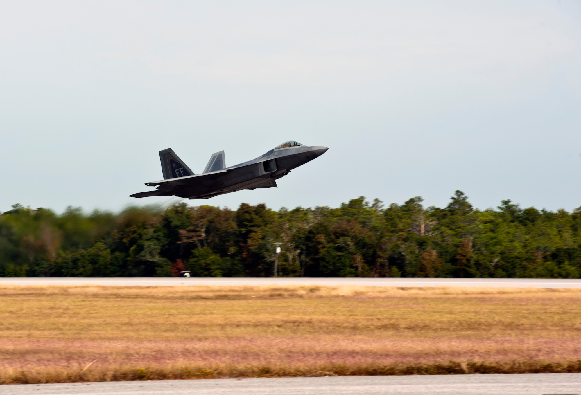 An F-22 Raptor takes off for an integrated training mission on Eglin Air Force Base, Florida, Nov. 5, 2014. The U.S. Air Force deployed four F-22A Raptors from Joint Base Langley-Eustis, Virginia, to Eglin Air Force Base, Florida, for the first operational integration training mission with the F-35A Lightning II assigned to the 33rd Fighter Wing. The purpose of the training was to improve integrated employment of fifth-generation assets and tactics. (U.S. Air Force photo/Staff Sgt. Marleah Robertson)