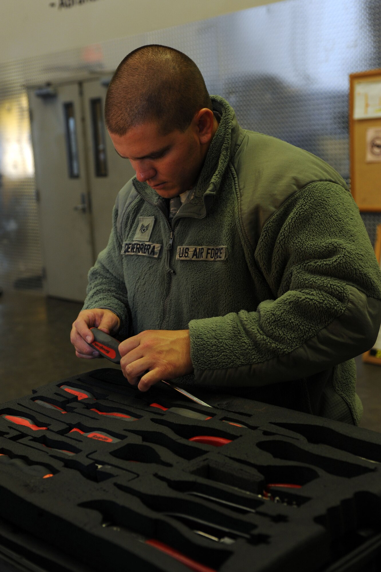 Staff Sgt. Daniel DeHerrera, 28th Maintenance Group quality assurance inspector, examines tools during a quality assurance inspection at Ellsworth Air Force Base, S.D., Nov. 12, 2014. As a QA inspector, DeHerrera ensures quality maintenance and training is being conducted, helping keep the B-1 bomber combat ready at a moment’s notice. (U.S. Air Force photo by Senior Airman Hailey R. Staker/Released)