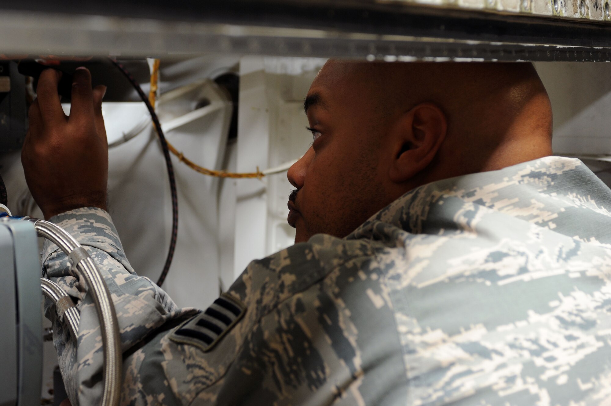 Staff Sgt. Lorenzo Woodard, 28th Aircraft Maintenance Squadron communication navigation mission systems lead technician, installs a radar component on a B-1 Bomber at Ellsworth Air Force Base, S.D., Nov. 12, 2014. The 28th Maintenance Group quality assurance inspectors perform personal evaluations to ensure quality maintenance is being performed, both correctly and safely. (U.S. Air Force photo by Senior Airman Hailey R. Staker/Released)