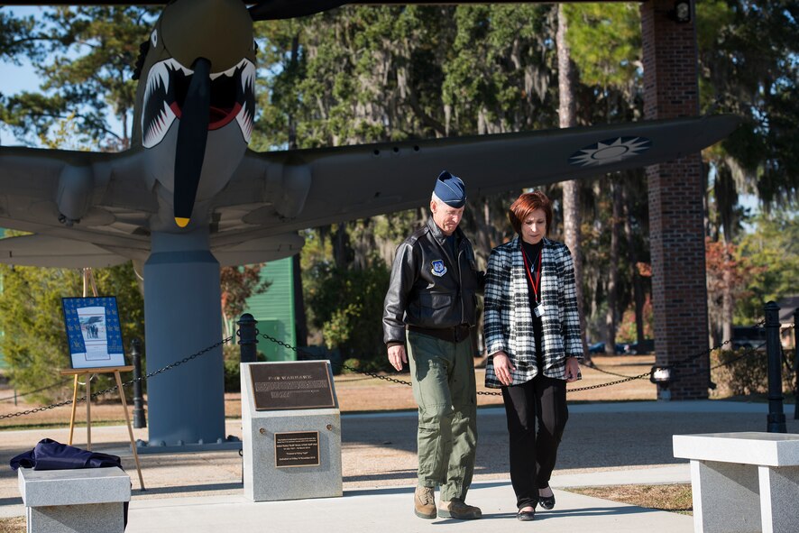 U.S. Air Force Col. Scott Cane, left, Ninth Air Force vice commander, comforts Martha Brown, wife of retired Lt. Col. Robert “Muck” Brown, after they unveiled the plaque dedicating the P-40 Warhawk pavilion to her deceased husband as part of the Flying Tiger Reunion Nov. 14, 2014, at Moody Air Force Base, Ga. Brown was an A-10C Thunderbolt II pilot with more than 3,100 flight-hours throughout his 20-year career. (U.S. Air Force photo by Airman 1st Class Ryan Callaghan/Released)
