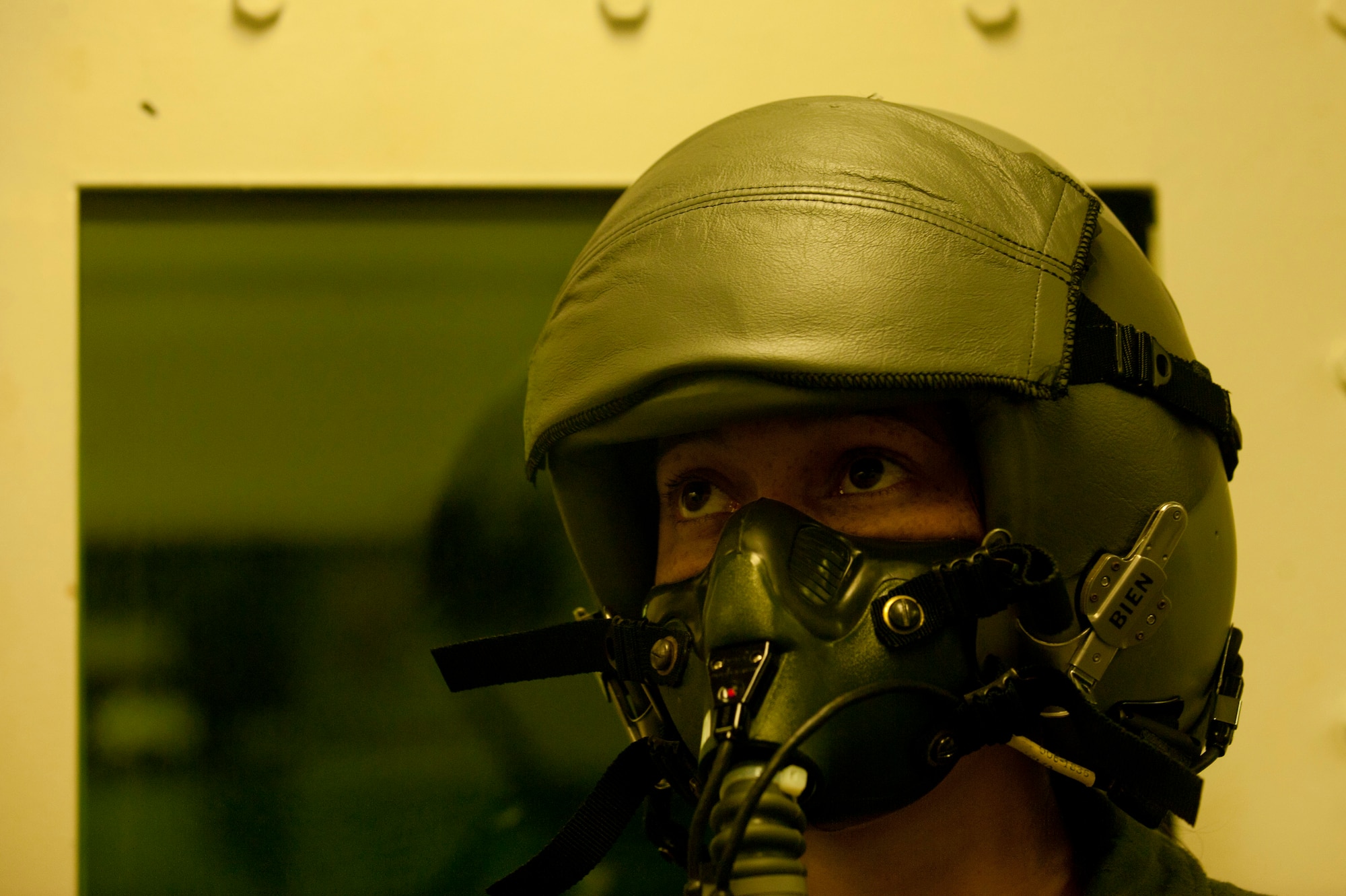 U.S. Air Force Senior Airman Francia Bienvue, 633rd Aerospace Medicine Squadron physiology technician, dons her mask before going through a rapid decompression test with high-altitude training students in a hypobaric altitude chamber at Langley Air Force Base, Va., Nov. 14, 2014. Students go through a series of tests that bring on hypoxia and add pressure to sinus cavities. (U.S. Air Force photo by Staff Sgt. Natasha Stannard/Released)