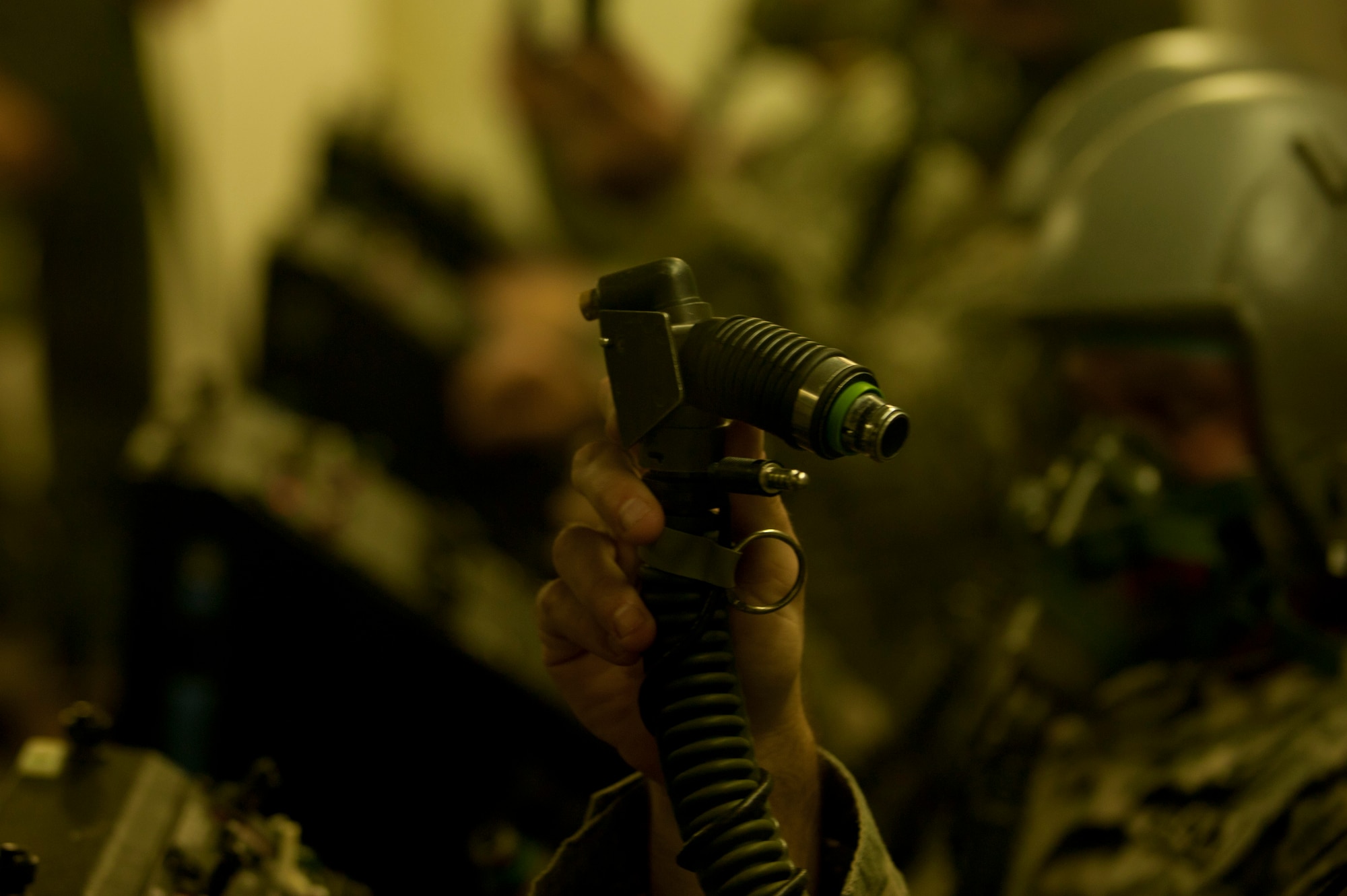 A U.S. Army Ranger displays his connector regulator unit-60/P as a hypobaric altitude chamber instructor goes over what the 60/P is used for and how to use it at Langley Air Force Base, Va., Nov. 14, 2014. The 60/P connects the oxygen mask to the supply hose or emergency high pressure system. (U.S. Air Force photo by Staff Sgt. Natasha Stannard/Released) 