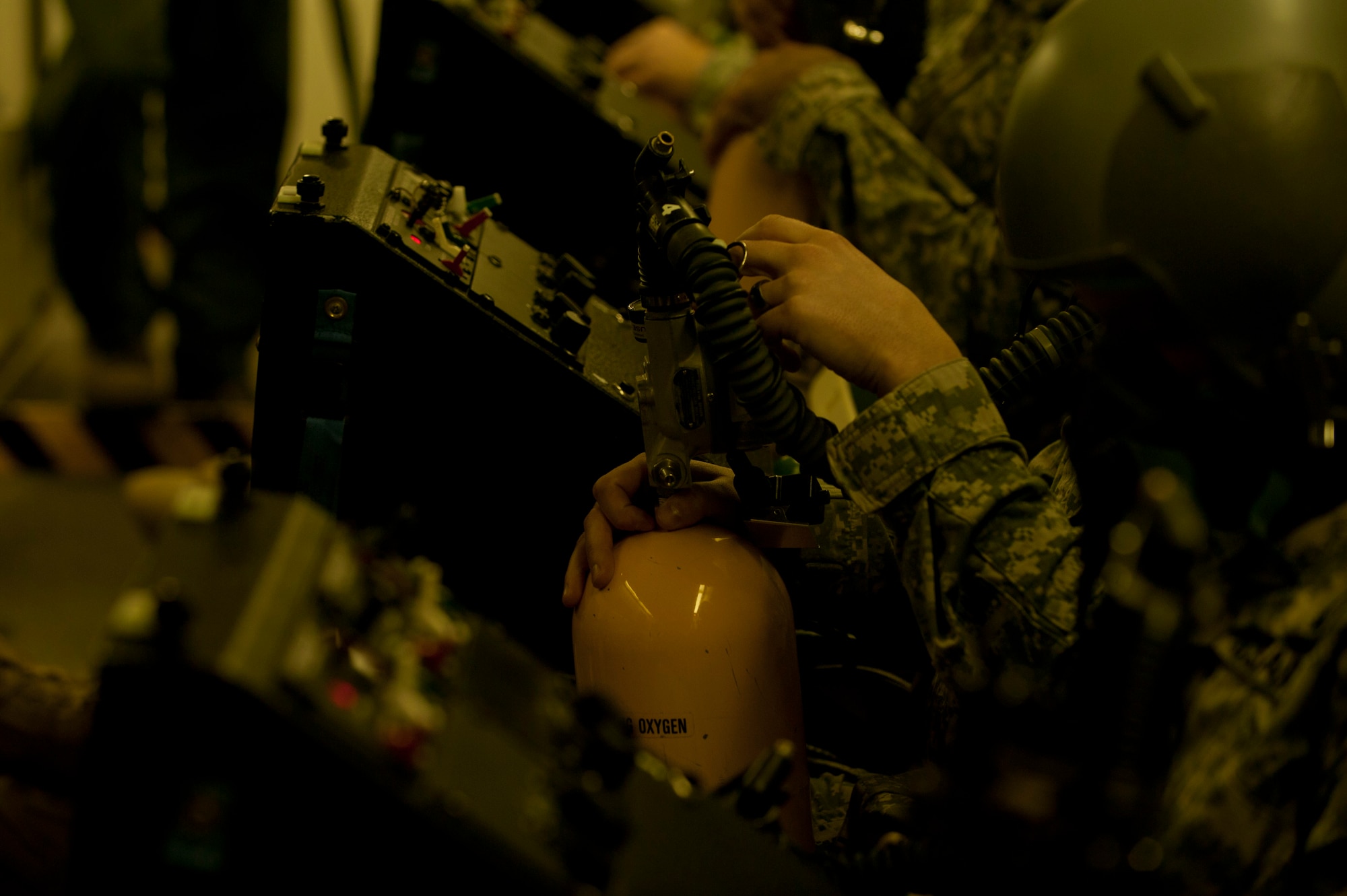 A U.S. Army Ranger makes adjustments to his MA-1 portable oxygen emergency back-up device as he is instructed on how to use it inside a hypobaric altitude chamber at Langley Air Force Base, Va., Nov. 14, 2014. The Rangers went through a series of tests that familiarized them with oxygen equipment used in high-altitude and emergency situations. (U.S. Air Force photo by Staff Sgt. Natasha Stannard/Released) 