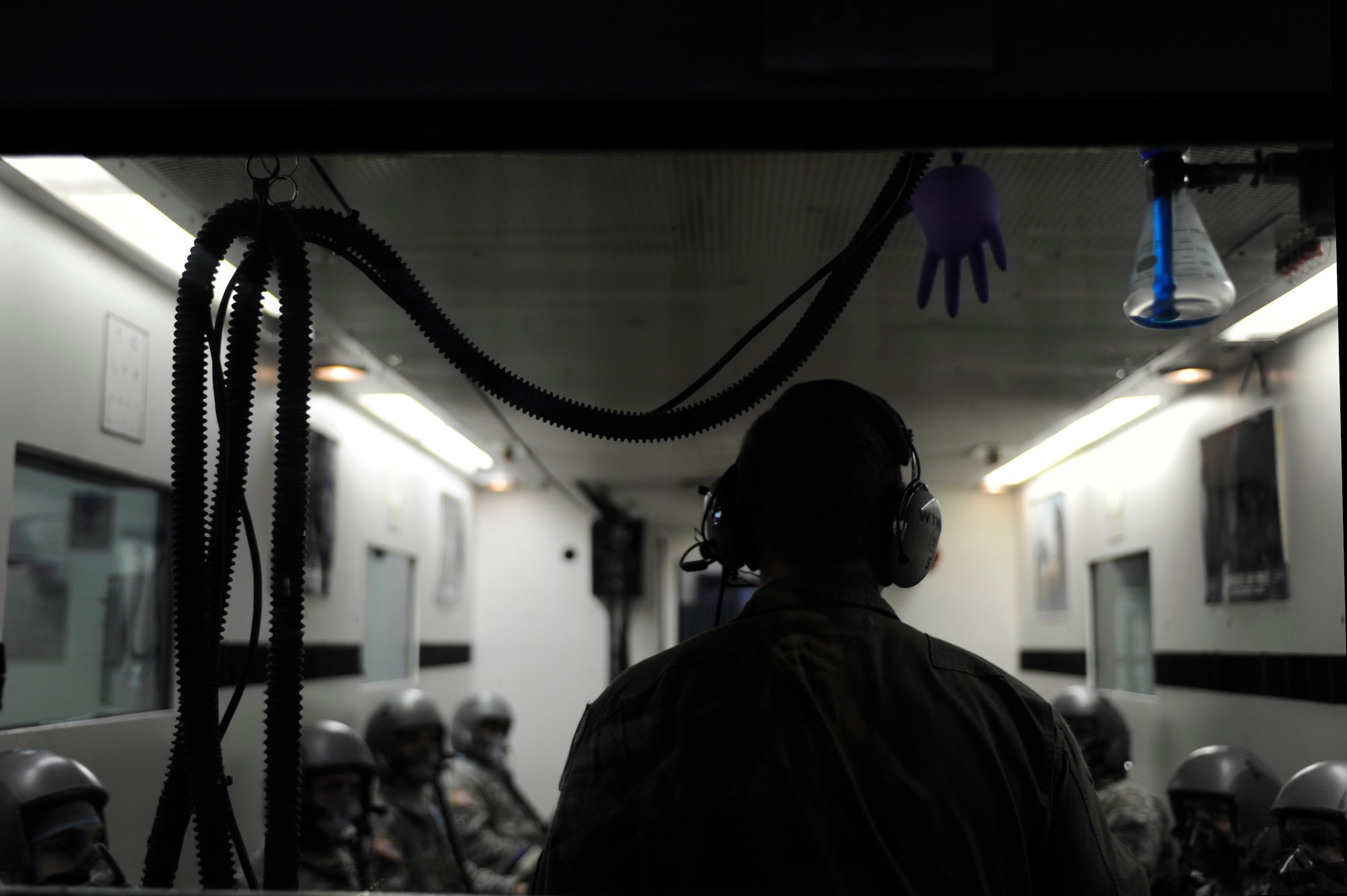 U.S. Air Force Senior Airman Mason Wyman, 633rd Aerospace Medicine Squadron physiology technician, goes over hypobaric altitude chamber procedures before U.S. Army Rangers go through a series of tests at Langley Air Force Base, Va., Nov. 14, 2014. The chamber tests train and familiarize participants in physiological threats associated with flying.  (U.S. Air Force photo by Staff Sgt. Natasha Stannard/Released)