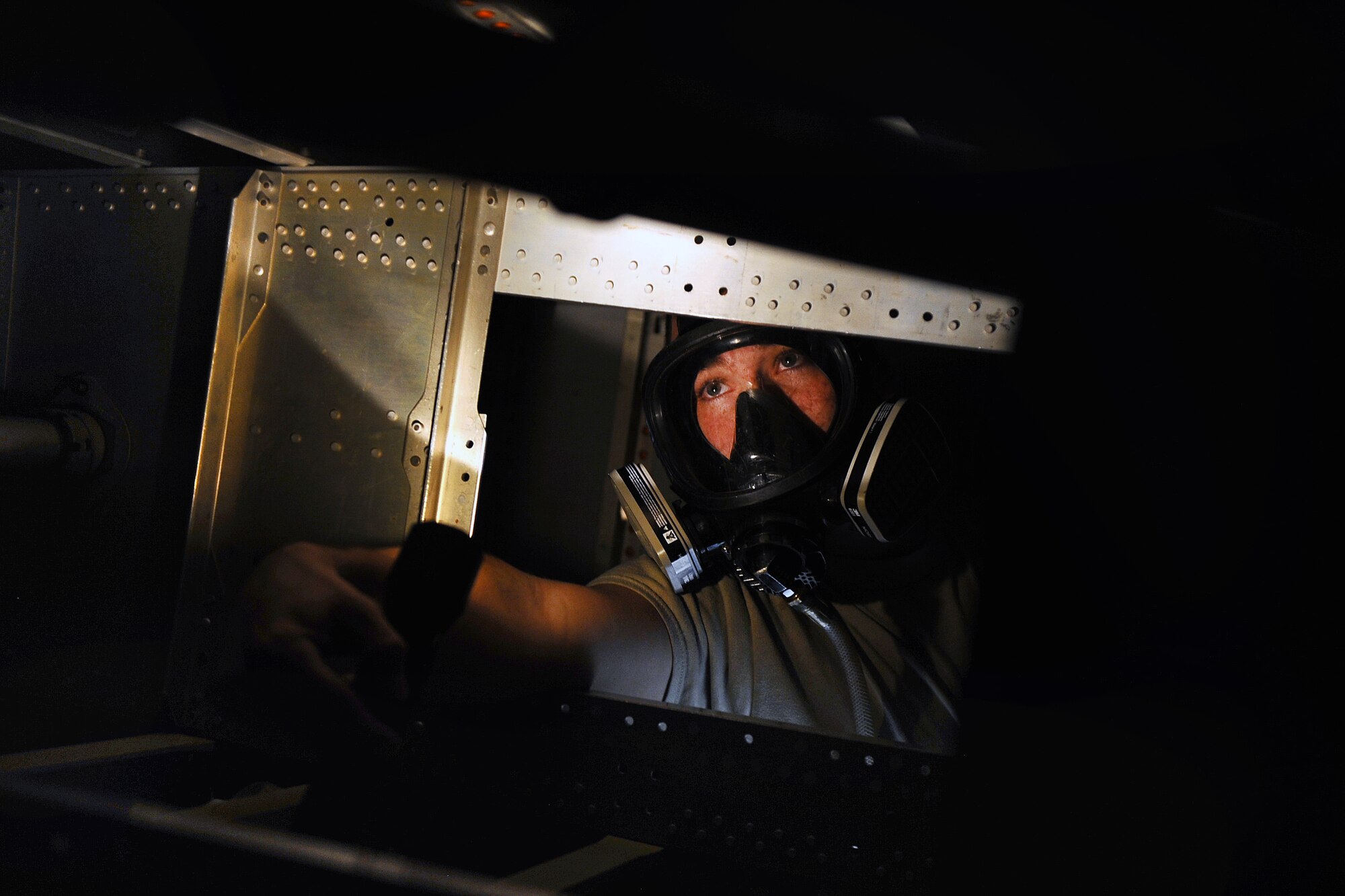 U.S. Air Force Senior Airman Mathew Wambles, who is assigned to the 55th Maintenance Squadron Fuel Systems Repair Shop, inspects the inside of a fuel cell following his safety training held Nov. 10 at Offutt Air Force Base, Neb.  Maintainers from the repair shop spend a lot of time in areas where space is incredibly limited.  (U.S. Air Force photo by Josh Plueger/Released)