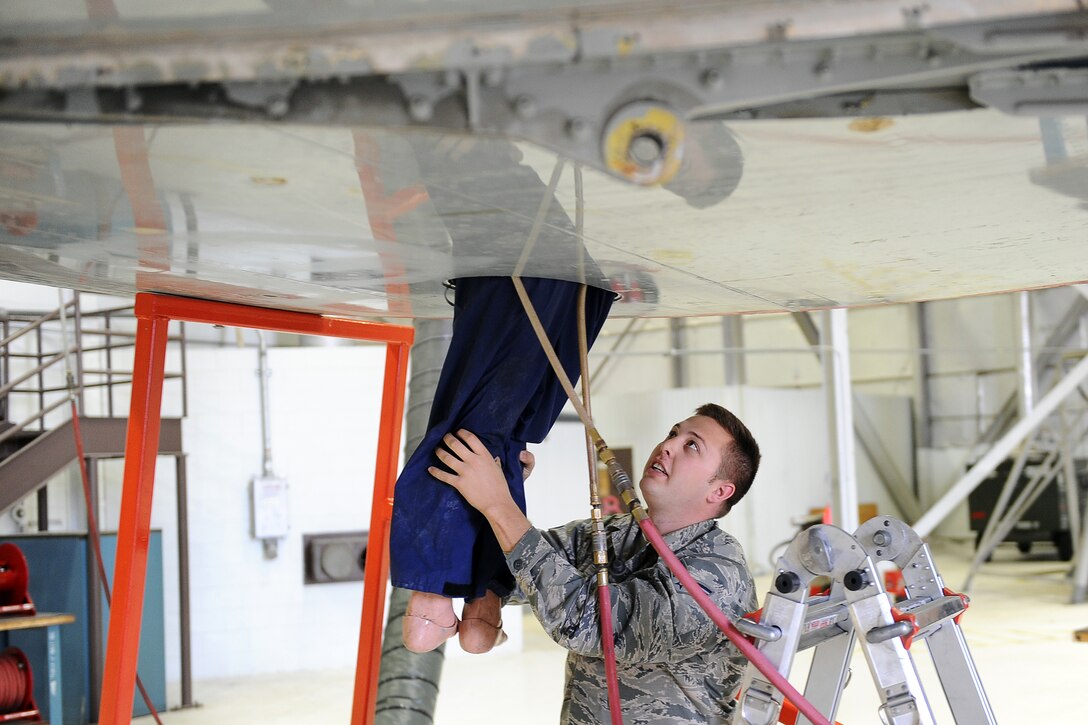 U.S. Air Force Senior Airman Kyle Quiggle, who is assigned to the 55th Maintenance Squadron Fuel Systems Repair Shop, rescues a dummy from a small opening on the bottom of a fuel cell as part of an annual Fuel Systems Extraction Exercise at Offutt Air Force Base, Neb., Nov. 10.  Small openings in the fuel cells allow just enough room for a repairman to enter and fix the any issues that may arise.  (U.S. Air Force photo by Josh Plueger/Released)